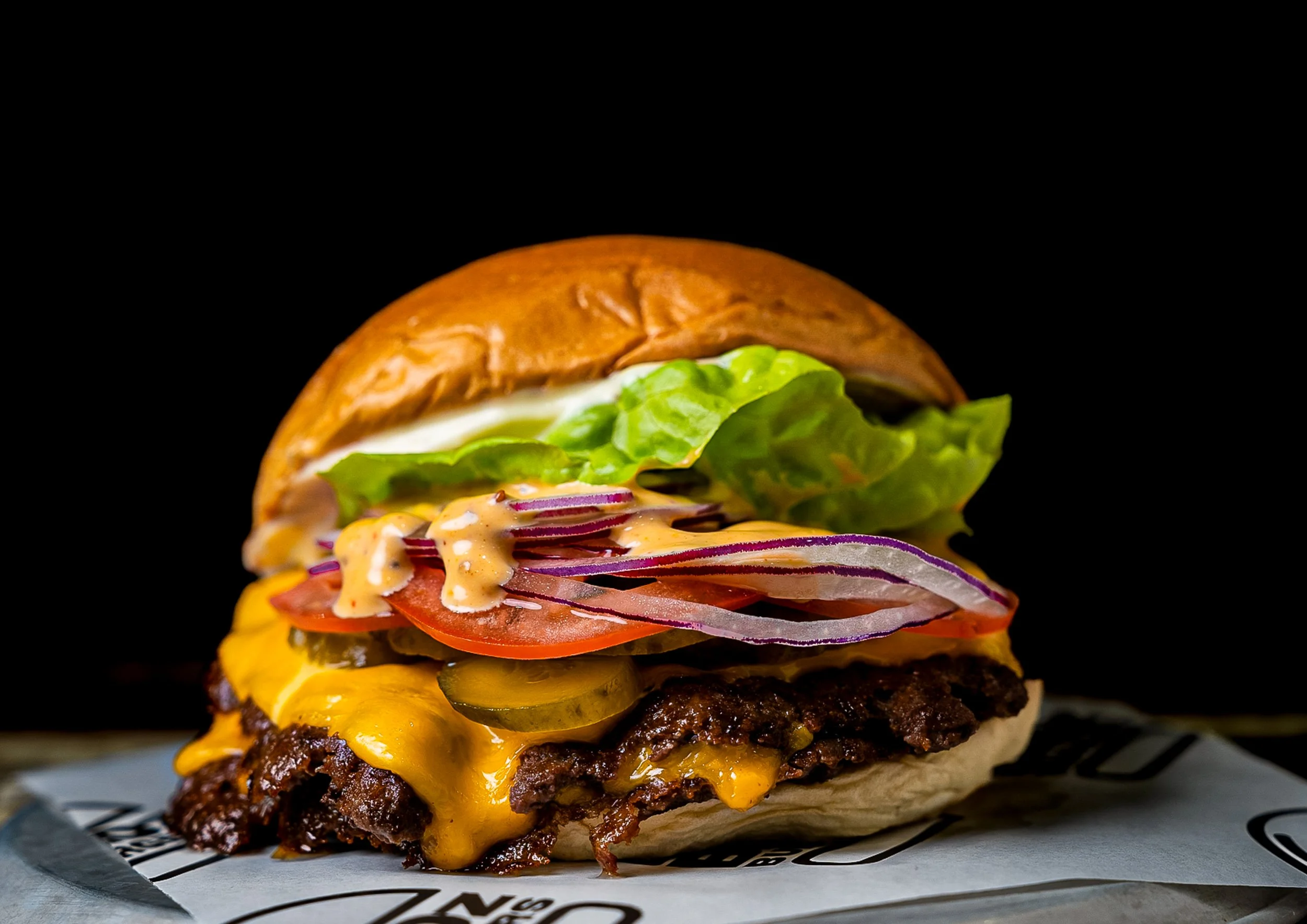Real smash cheeseburger from BrOz Burgers in Sydney with melted American cheese, pickles and toasted bun.