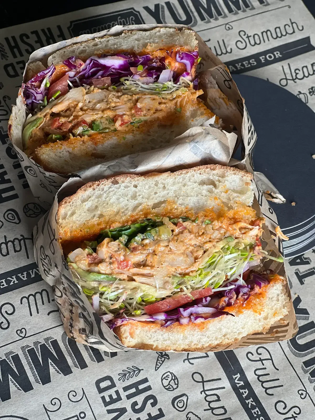 Truffle Lobsta jackfruit sandwich with vegetables and sprouts pictured from an earlier preparation