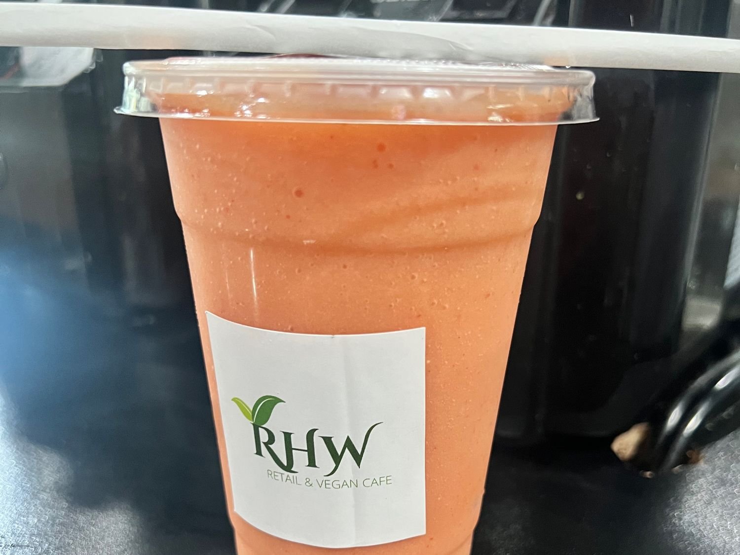RHW’s Strawberry Banana smoothie in a branded café cup.