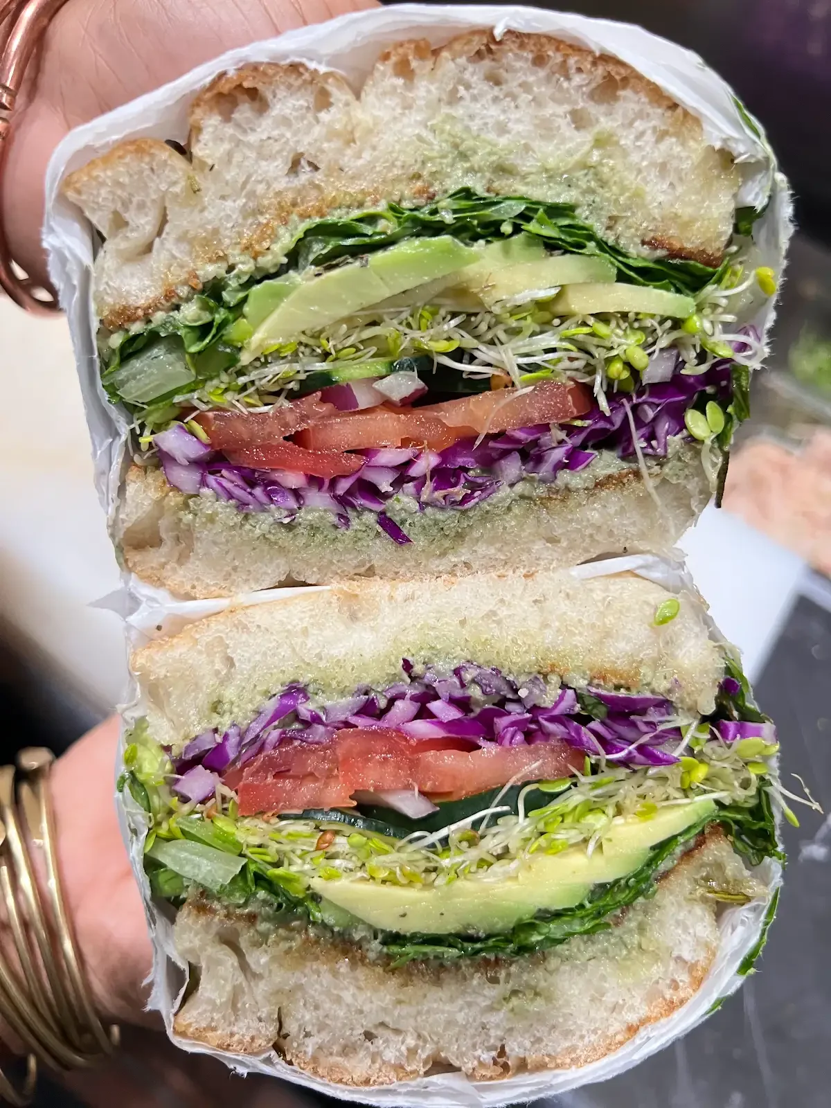 Basil Avo & Veggie sandwich with avocado, vegetables and sprouts pictured from an earlier preparation