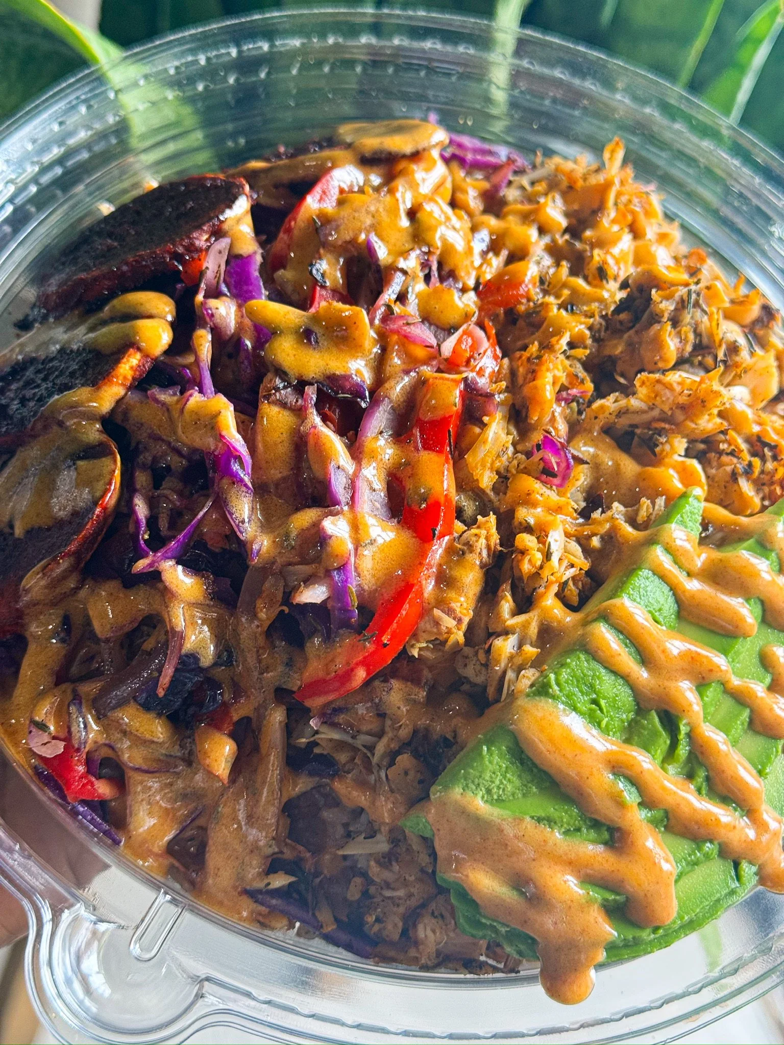 RHW plant-based bowl with avocado, vegetables, and sauce