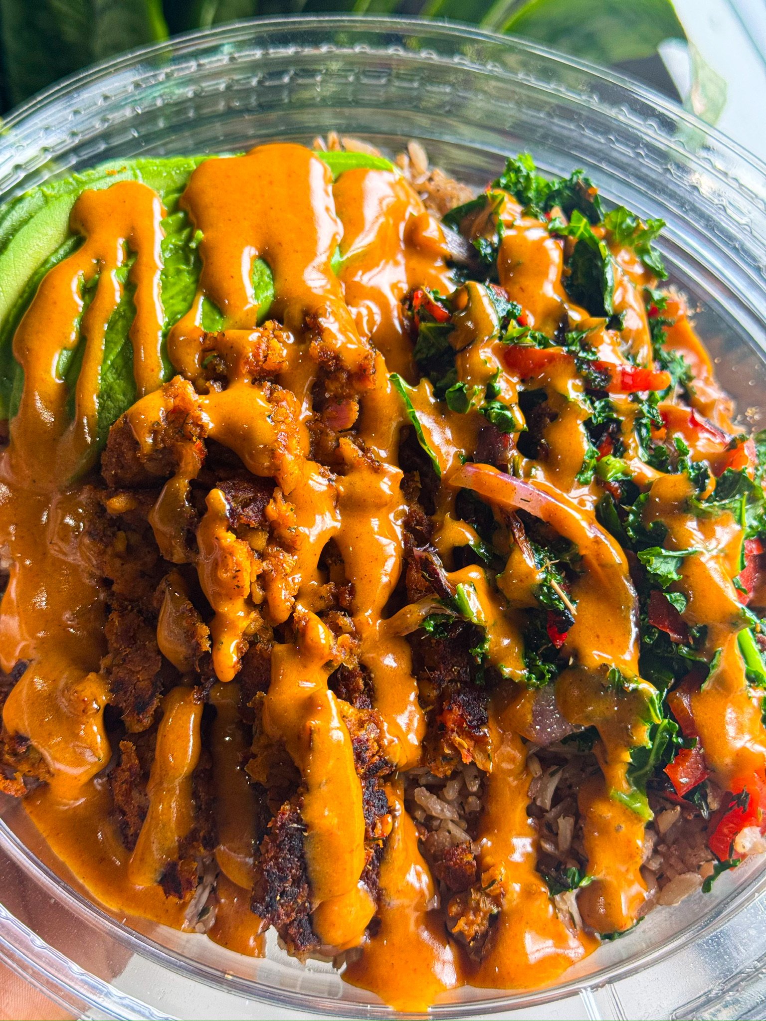 RHW plant-based bowl with avocado, greens, vegetables, and sauce