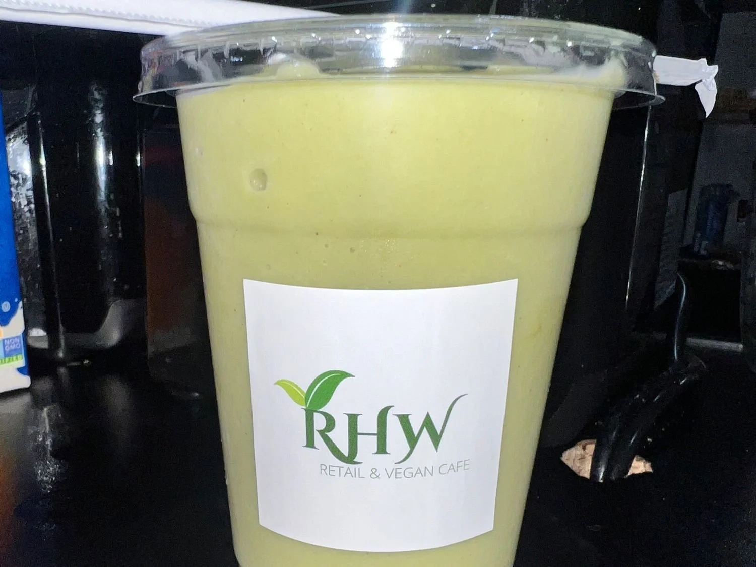 RHW’s Pineapple Matcha smoothie in a branded café cup.