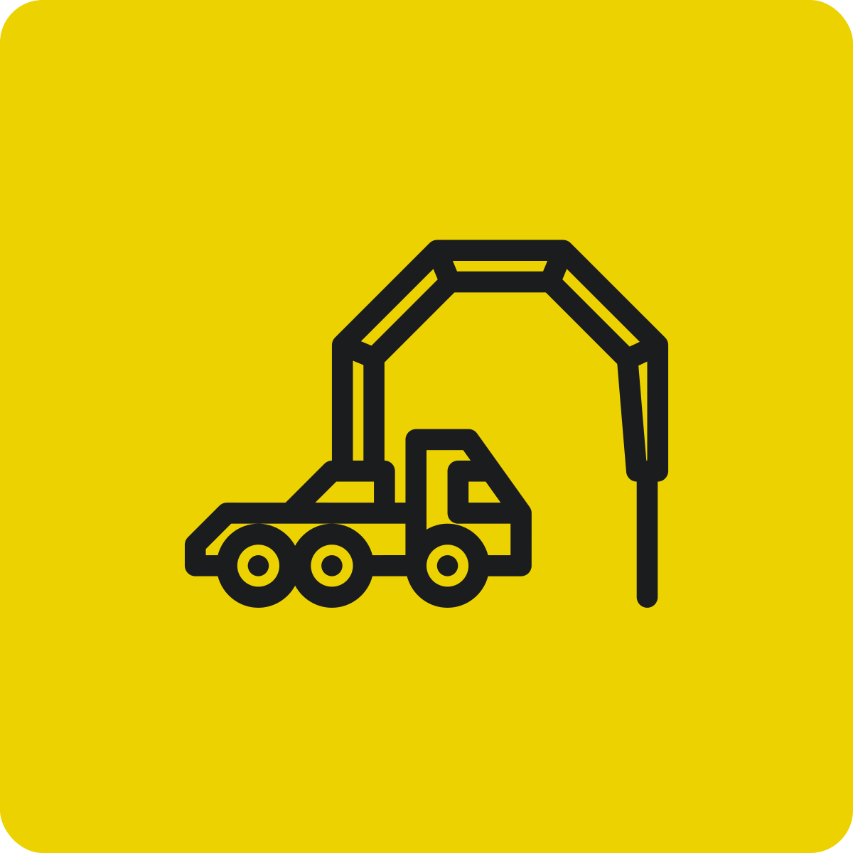 Construction warning sign with a black illustration of a dump truck and a crane on a yellow background