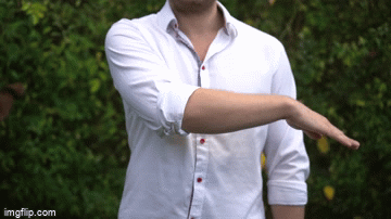 Person demonstrating a stretching or balance exercise outdoors.