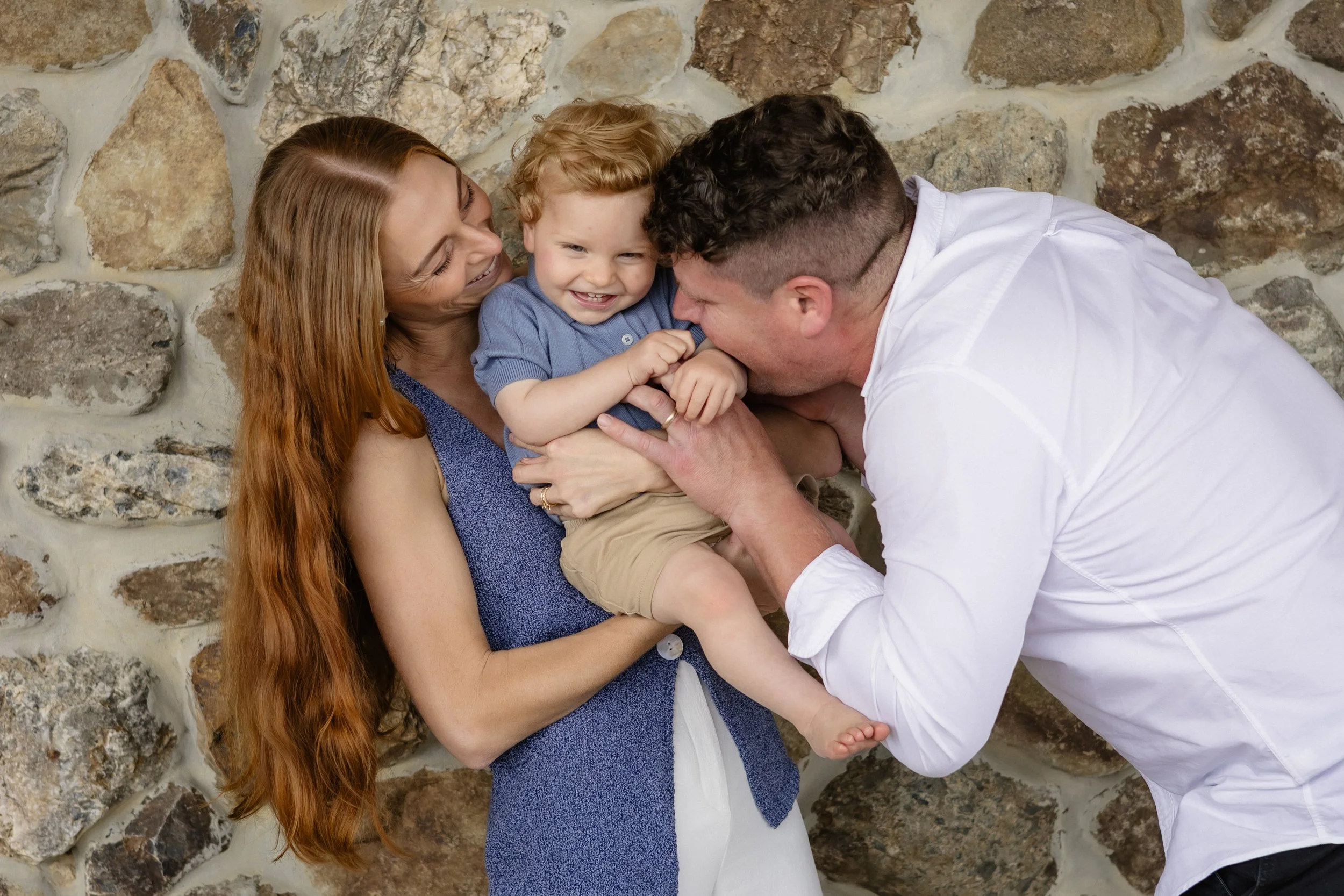 family laughing together during natural outdoor family photography session