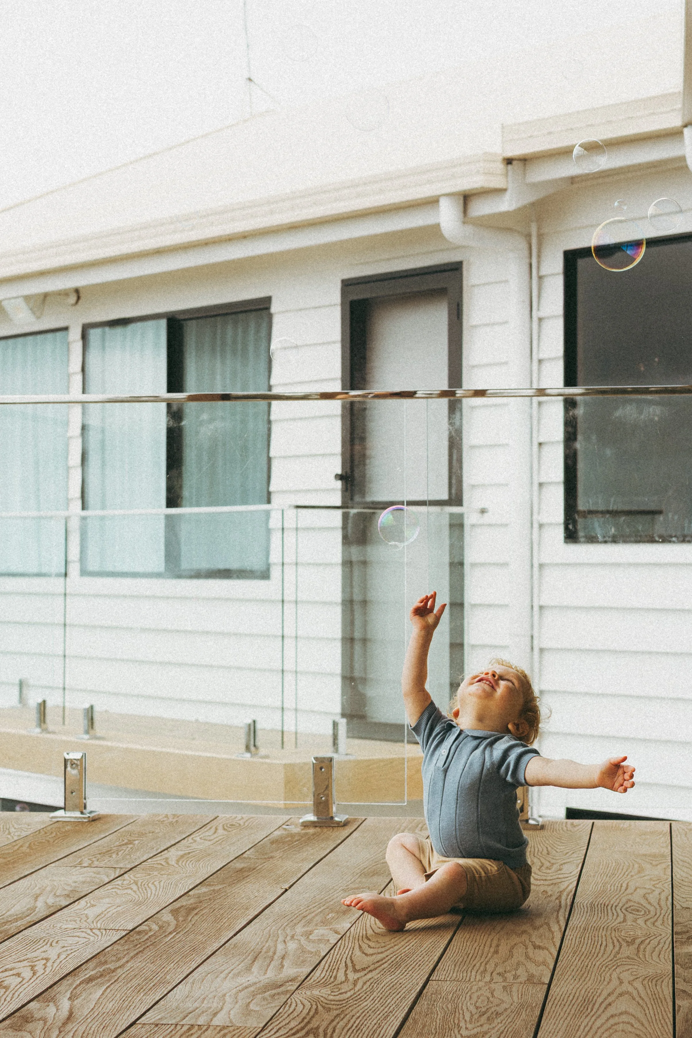 toddler playing with bubbles during a natural family photography session on the Gold Coast