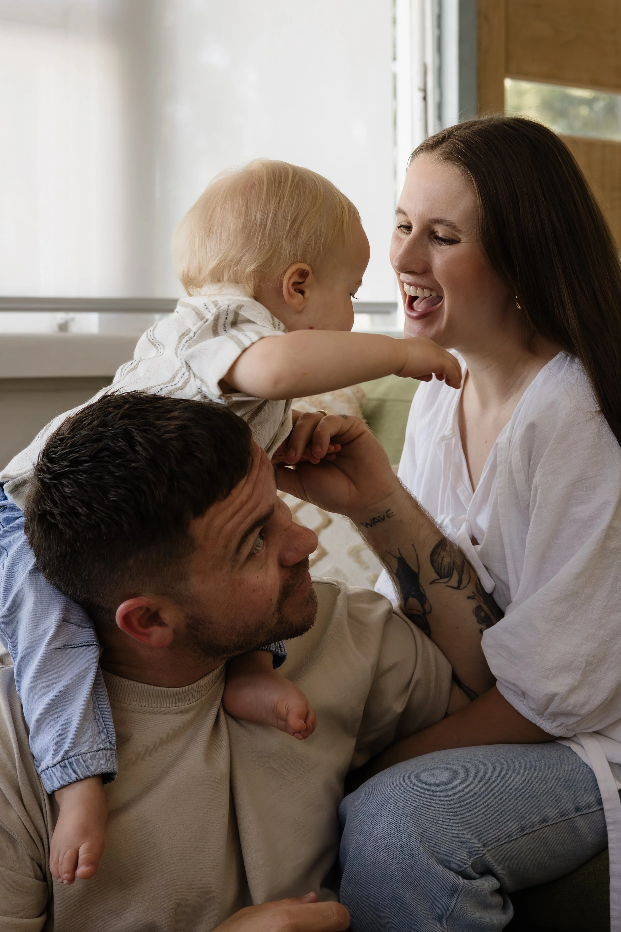 family cuddling with baby during in home lifestyle photography session on the Gold Coast 