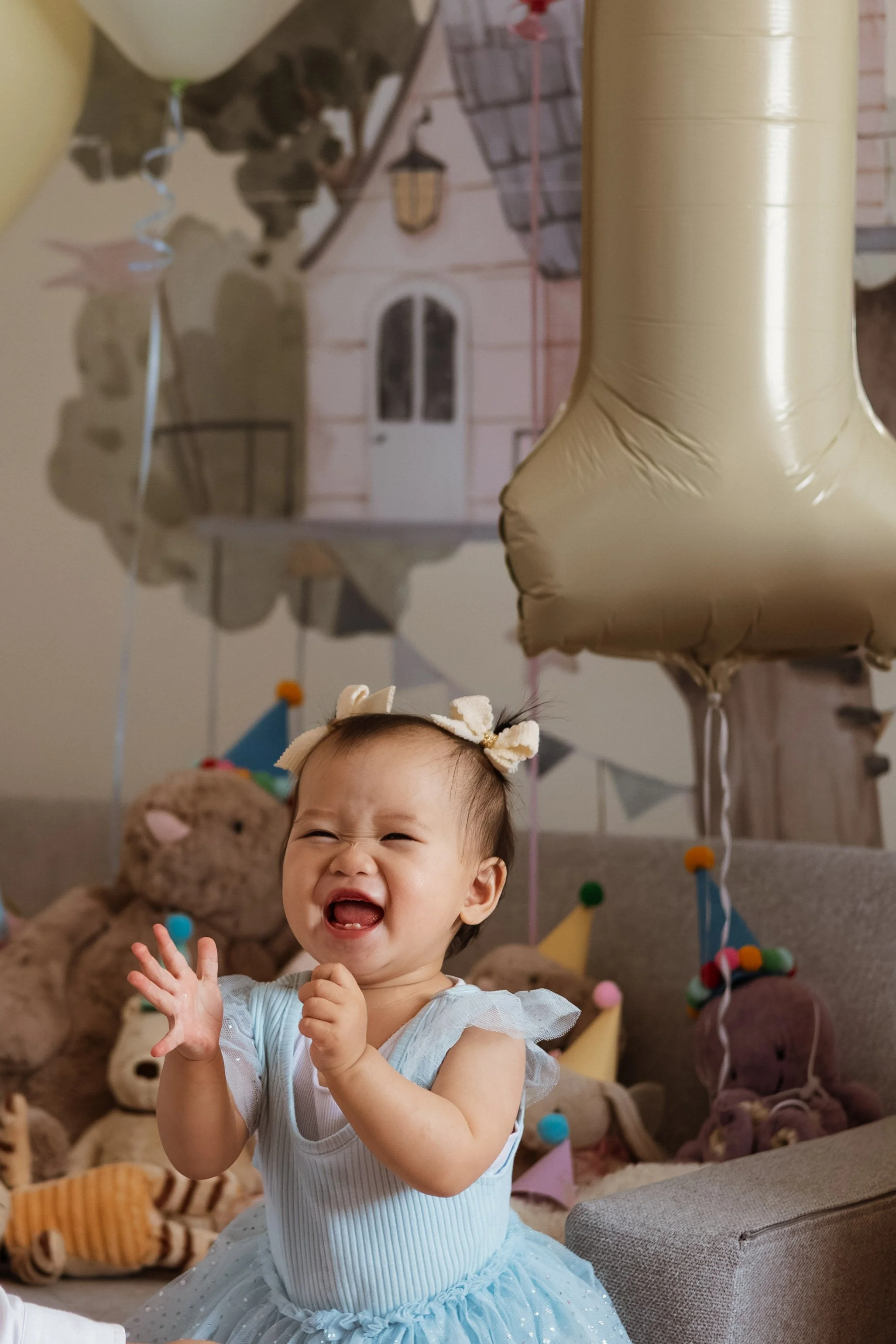 baby smiling during first birthday cake smash photography session