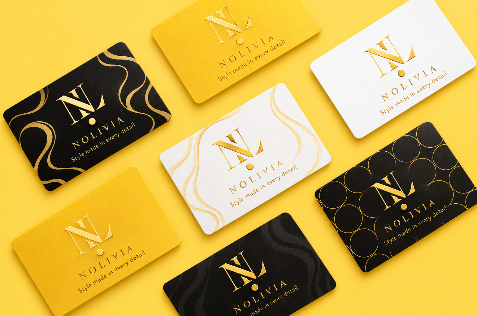 Collection of business cards for Nolivia with yellow, white, and black backgrounds, gold logo with 'N', and the slogan 'Style made in every detail' on each card, arranged on a yellow surface.