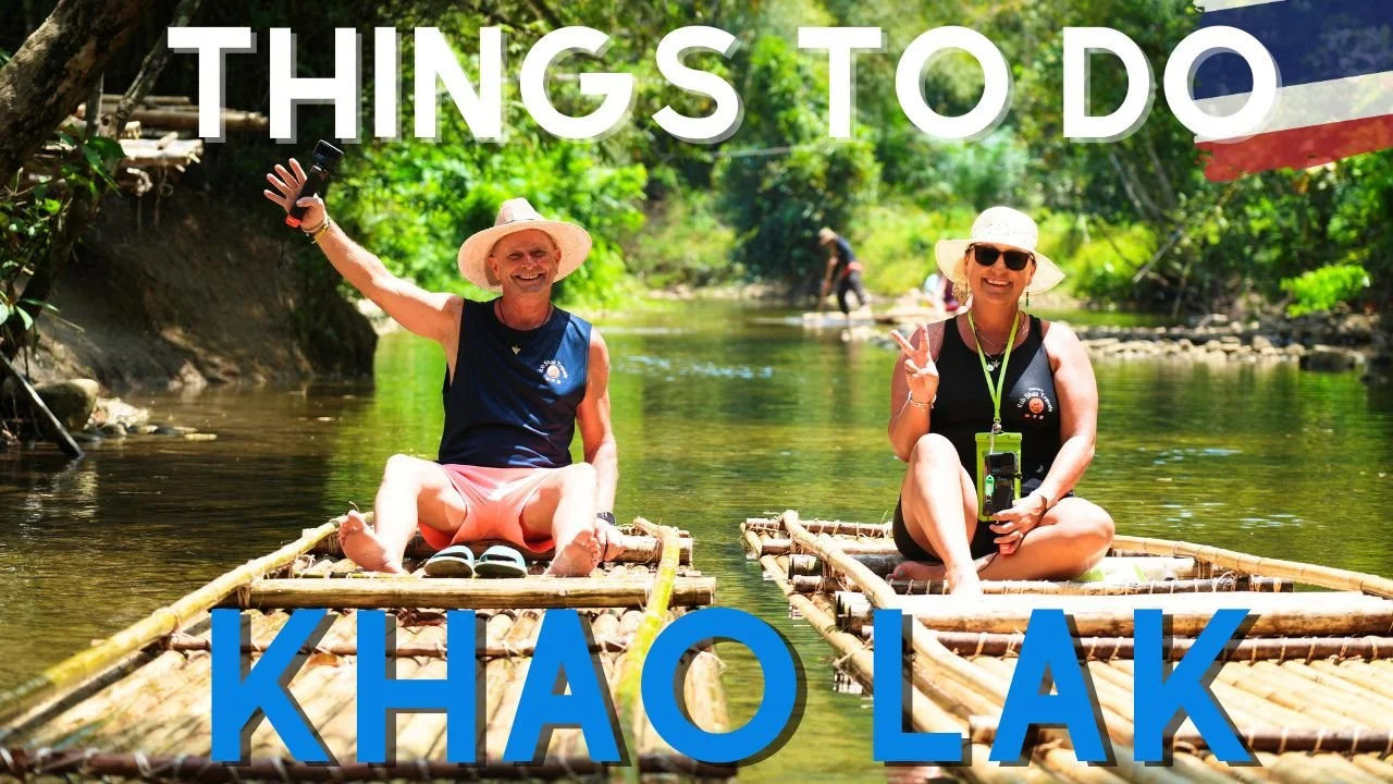 Two people sitting on bamboo rafts in a river, surrounded by green trees, wearing sun hats and sunglasses, smiling and making peace signs, with the text 'Things to Do Kho Lako' overlaid.