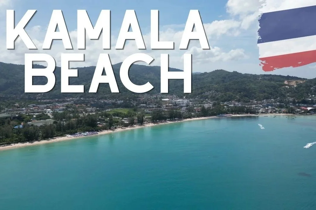 Aerial view of Kamala Beach in Thailand with turquoise water, a sandy shoreline, palm trees, and mountains in the background, with large text overlaying the image reading 'KAMALA BEACH' and a partial Thai flag in the upper right corner.