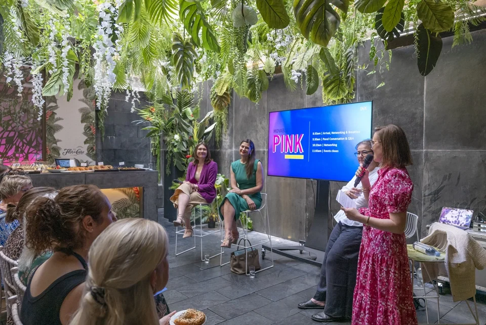 Tatiana Poliakova speaking on a panel at a women's leadership conference.