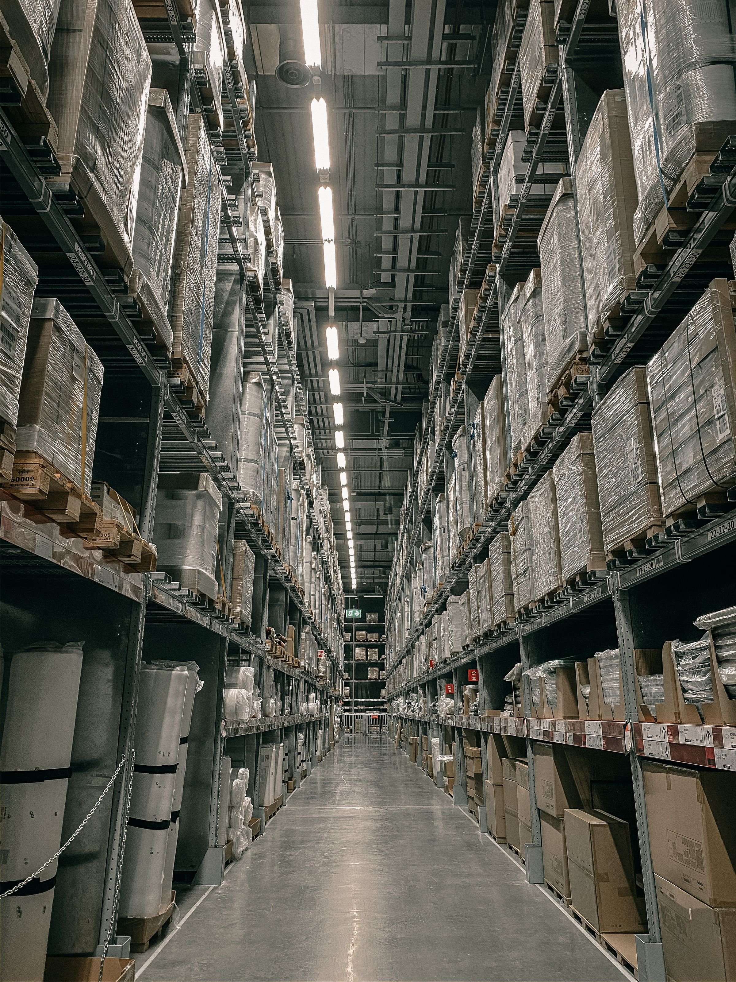 Shrink-wrapped pallets in a warehouse aisle