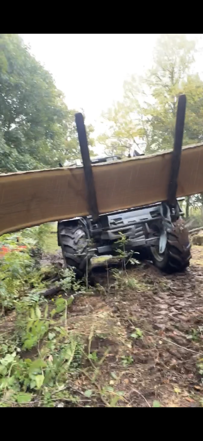 Tractor lifting large oak milled slab from gully. Local Tree Services Inverness. 