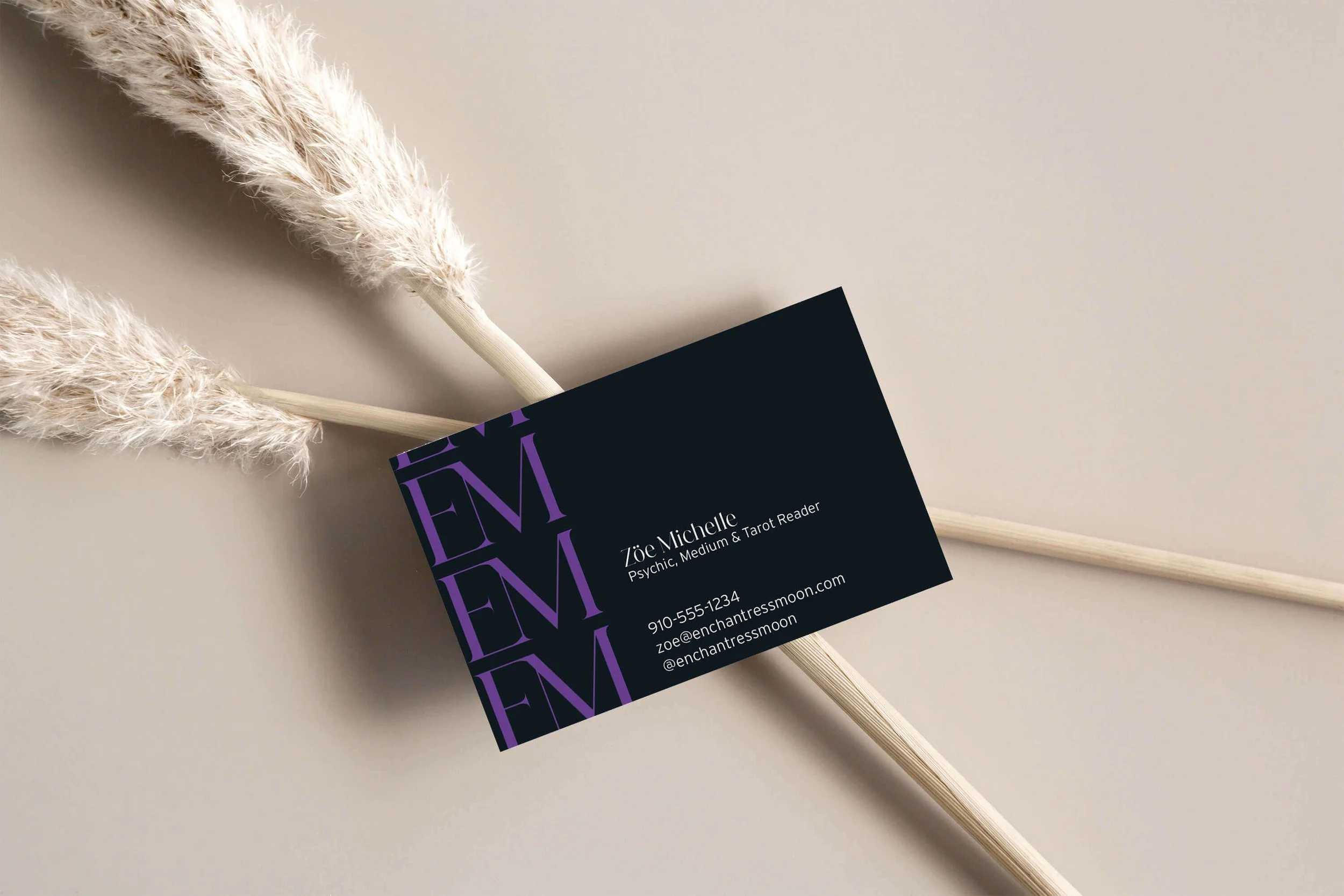 A business card featuring purple lettering on a clean background.