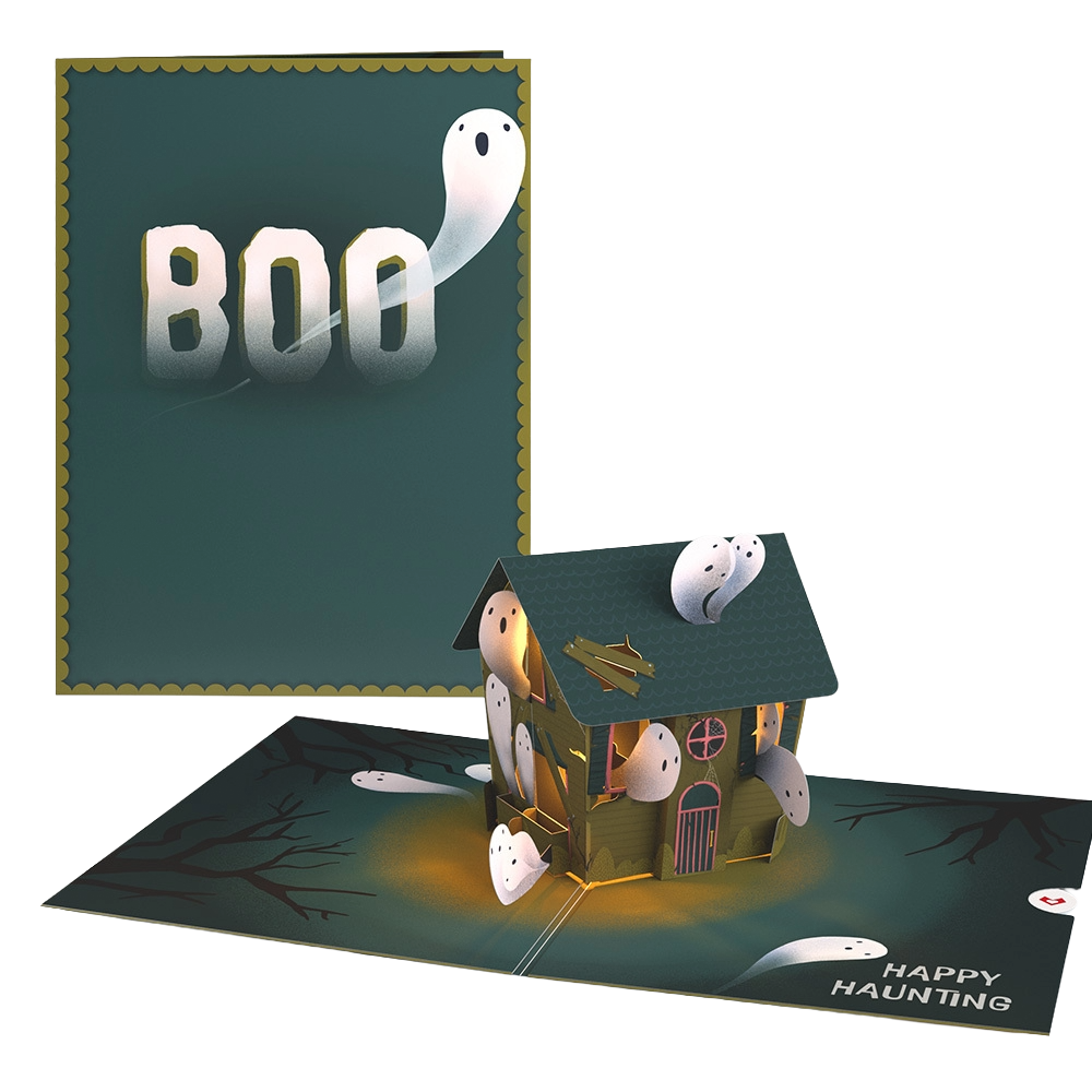 A pop-up Halloween haunted house card with ghost figures and a spooky scene, featuring a dark background with bare tree branches and the words "Happy Haunting."