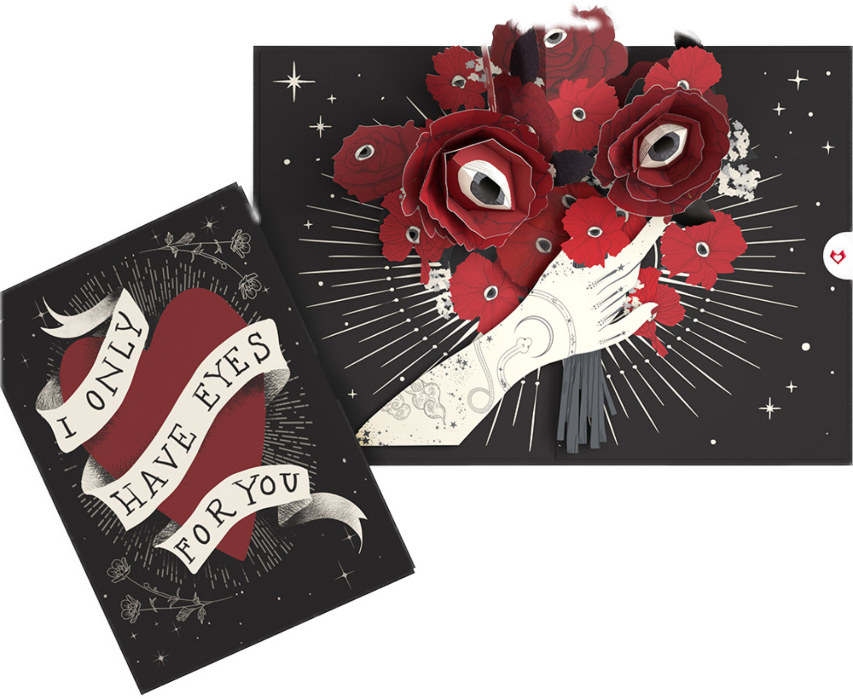 A pop-up greeting card with a bouquet of red flowers featuring eye details on a black background with stars and rays. The card in front says, "I have eyes for you."