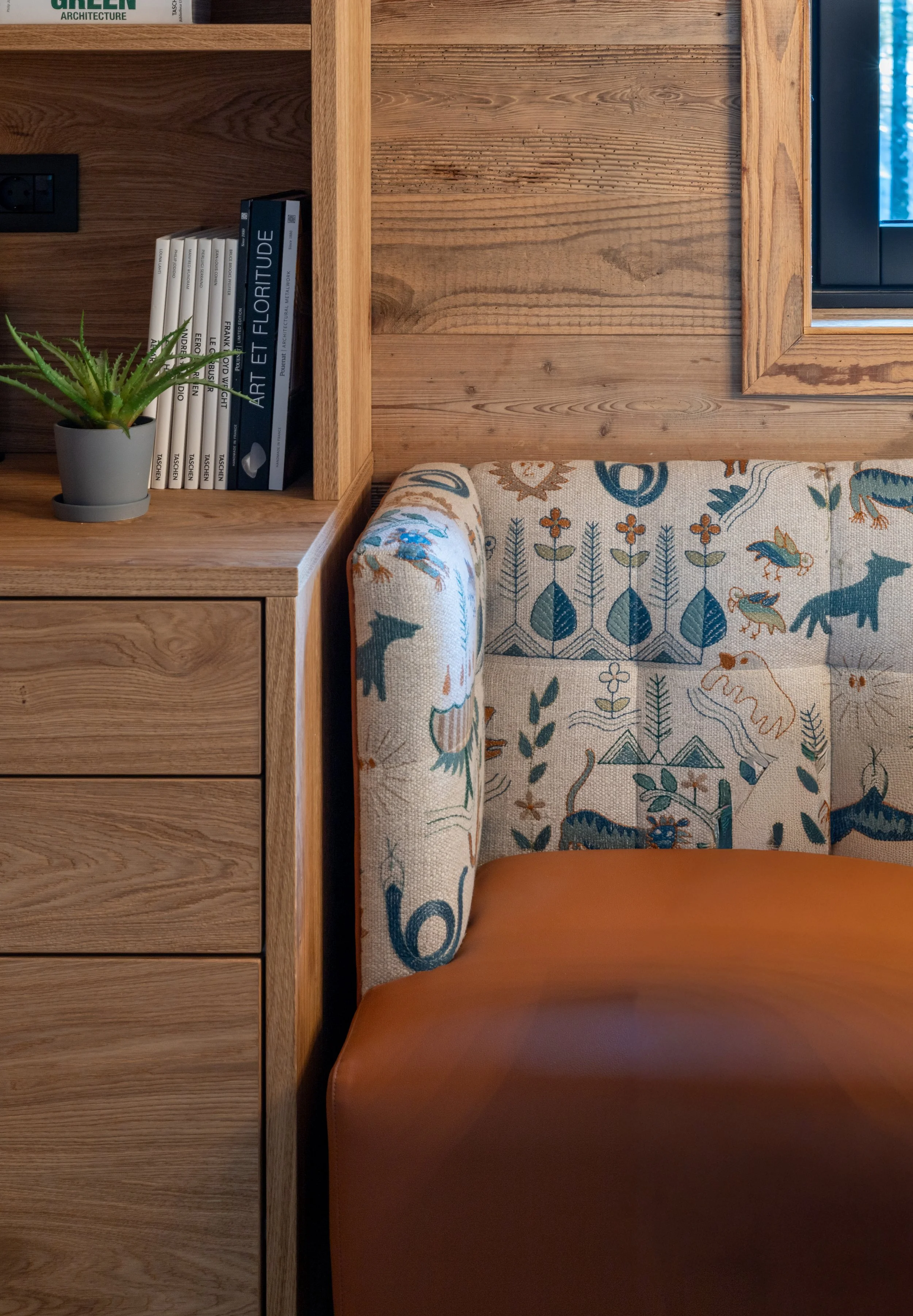 Embroidered linen and leather upholstered dining bench detail, mountain chalet Julian Alps