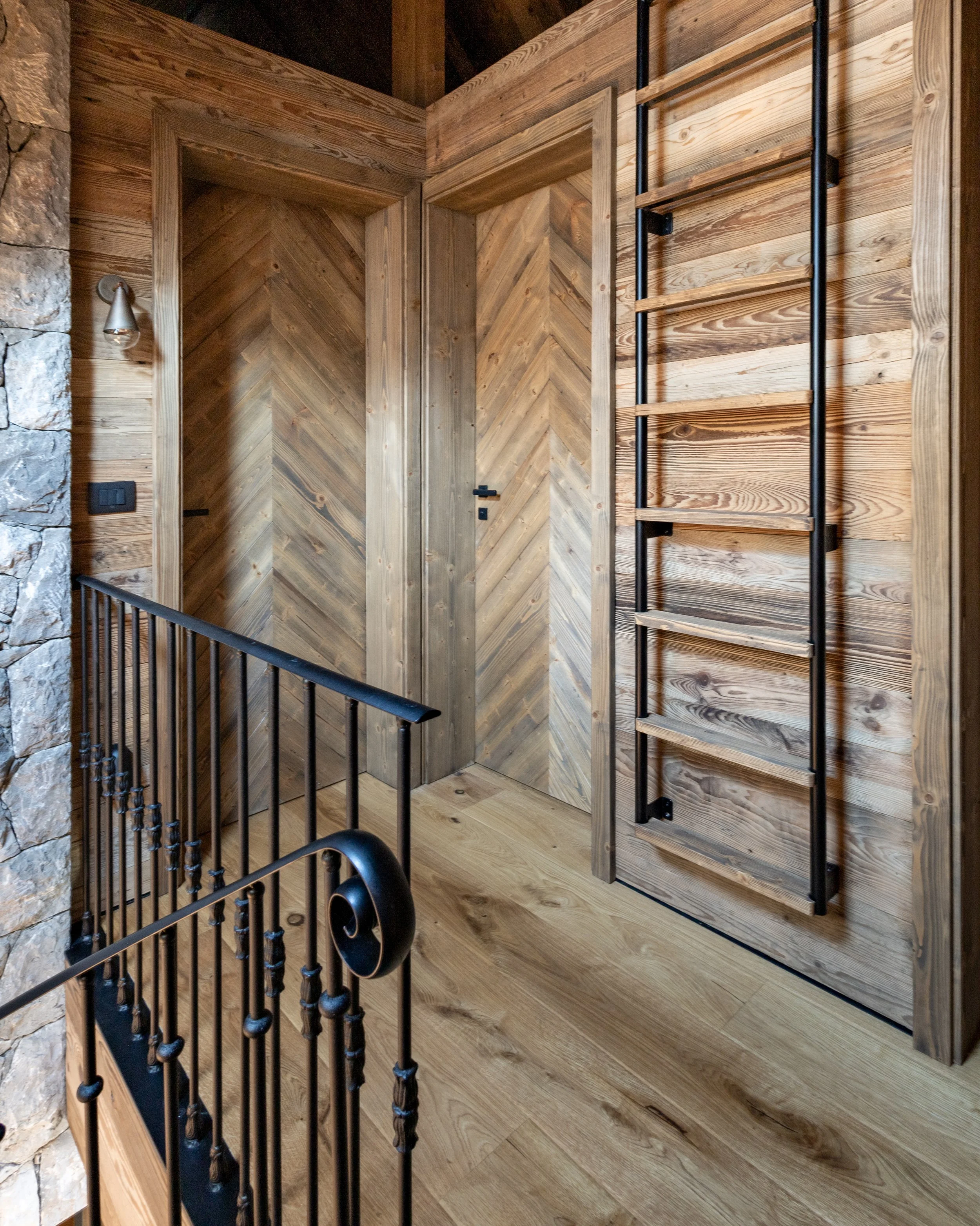 Wood panelling and herringbone doors, mountain chalet landing Julian Alps