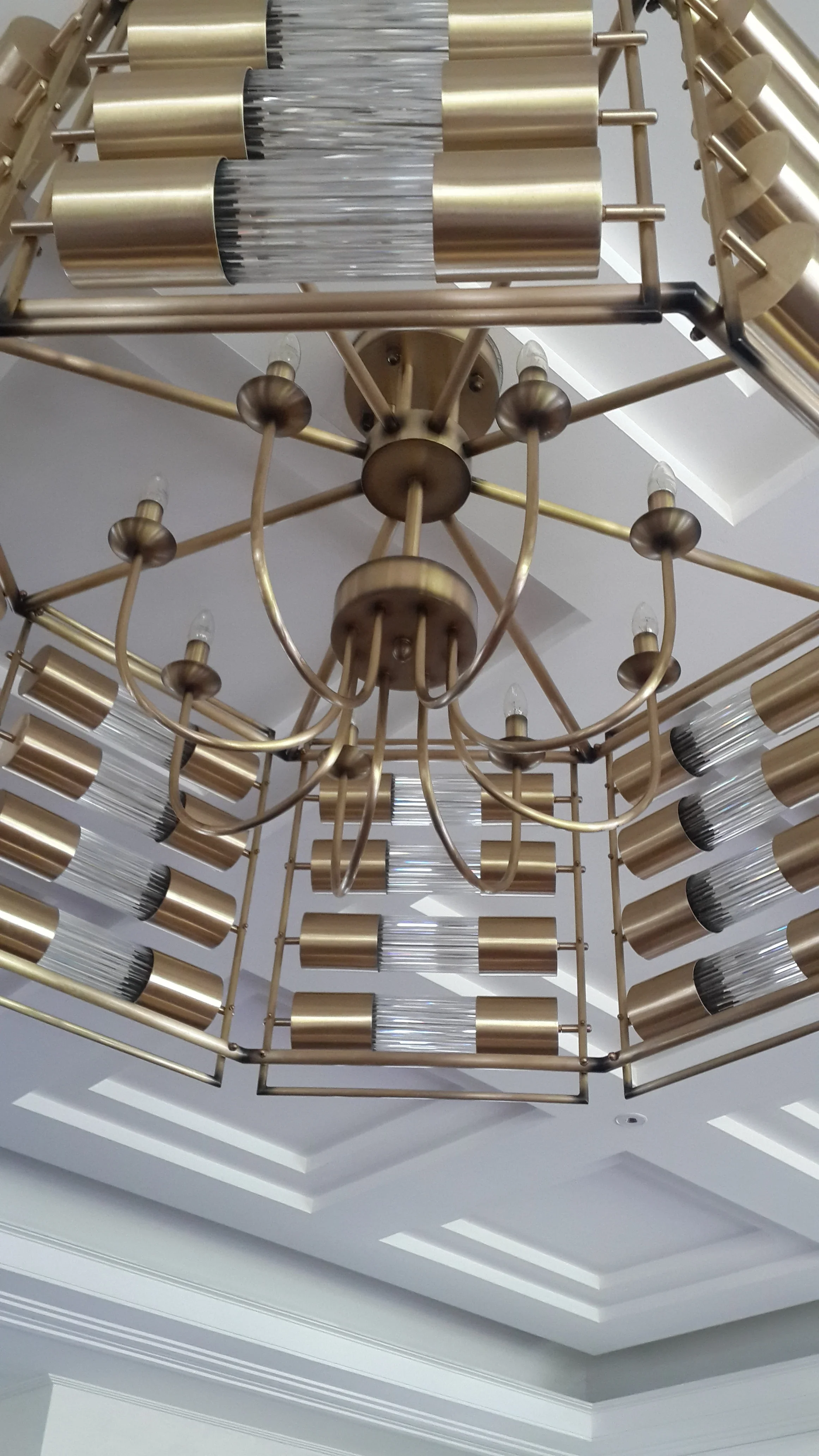 Brass and reeded glass chandelier detail Bandung residence