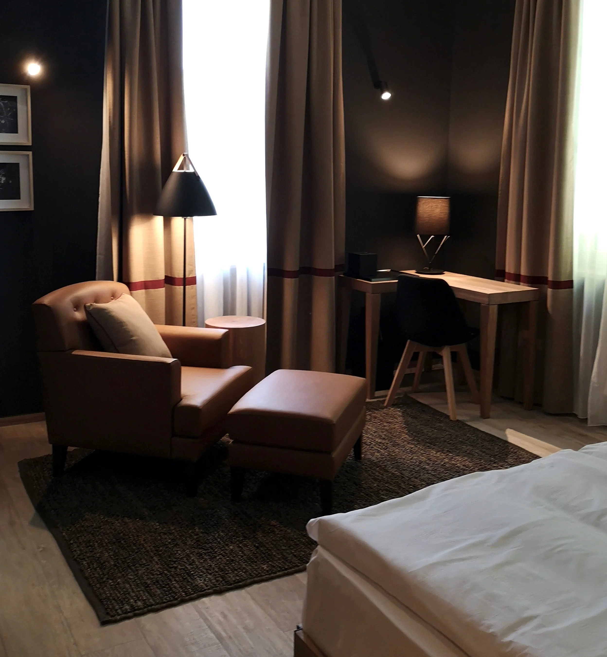 Leather upholstered armchair and ottoman, Chestnut Embrace room Sunrose 7 boutique hotel