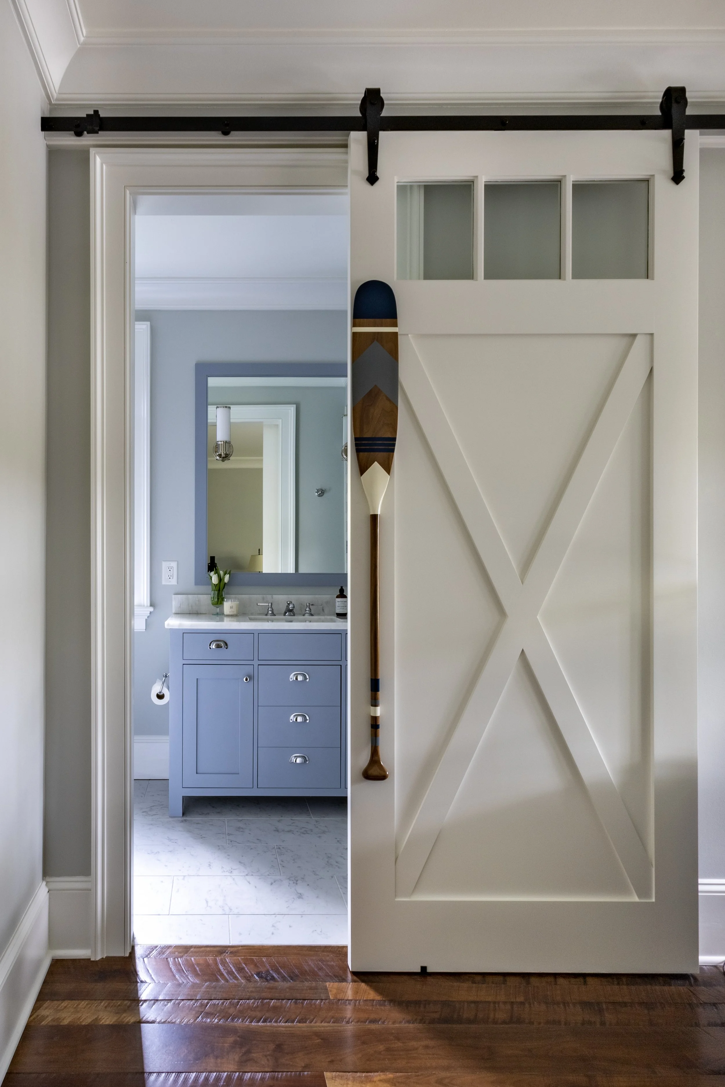 Barn door with oar handle sky blue bathroom Kiawah Island South Carolina