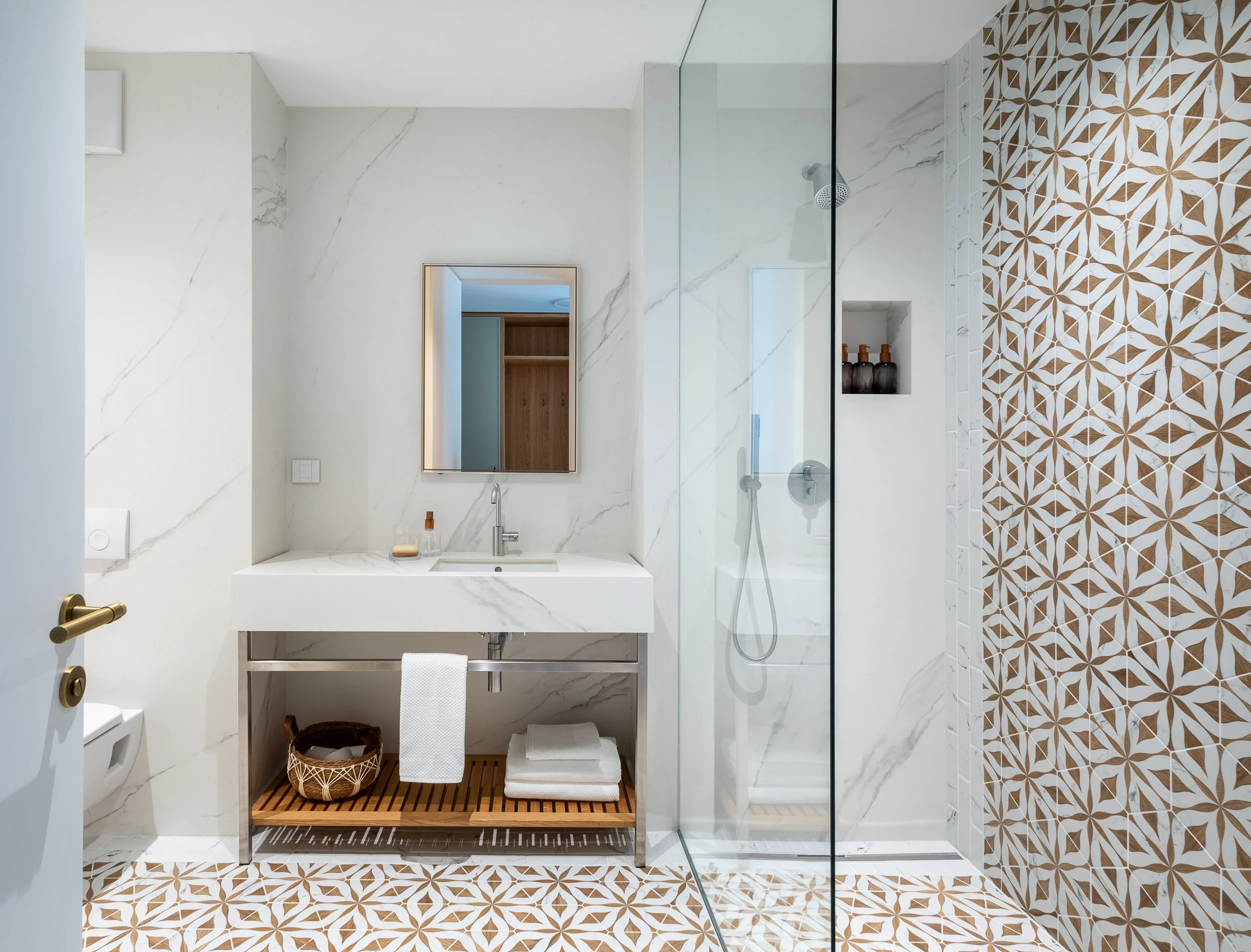 Hexagonal flower motif tiles and marble vanity Ljubljana Bezigrad apartment