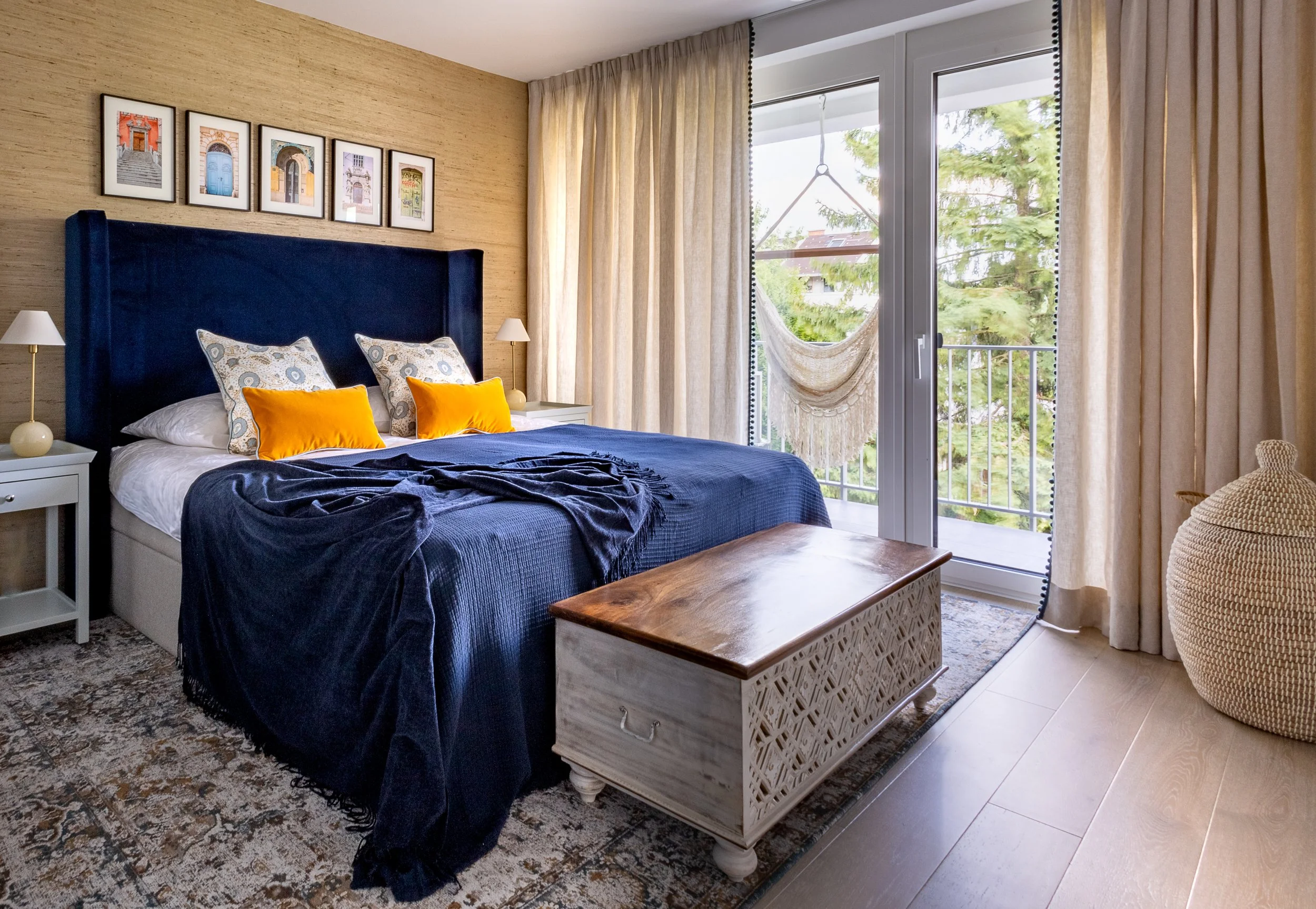 Carved blanket chest and blue upholstered bed, bedroom Ljubljana Bezigrad apartment