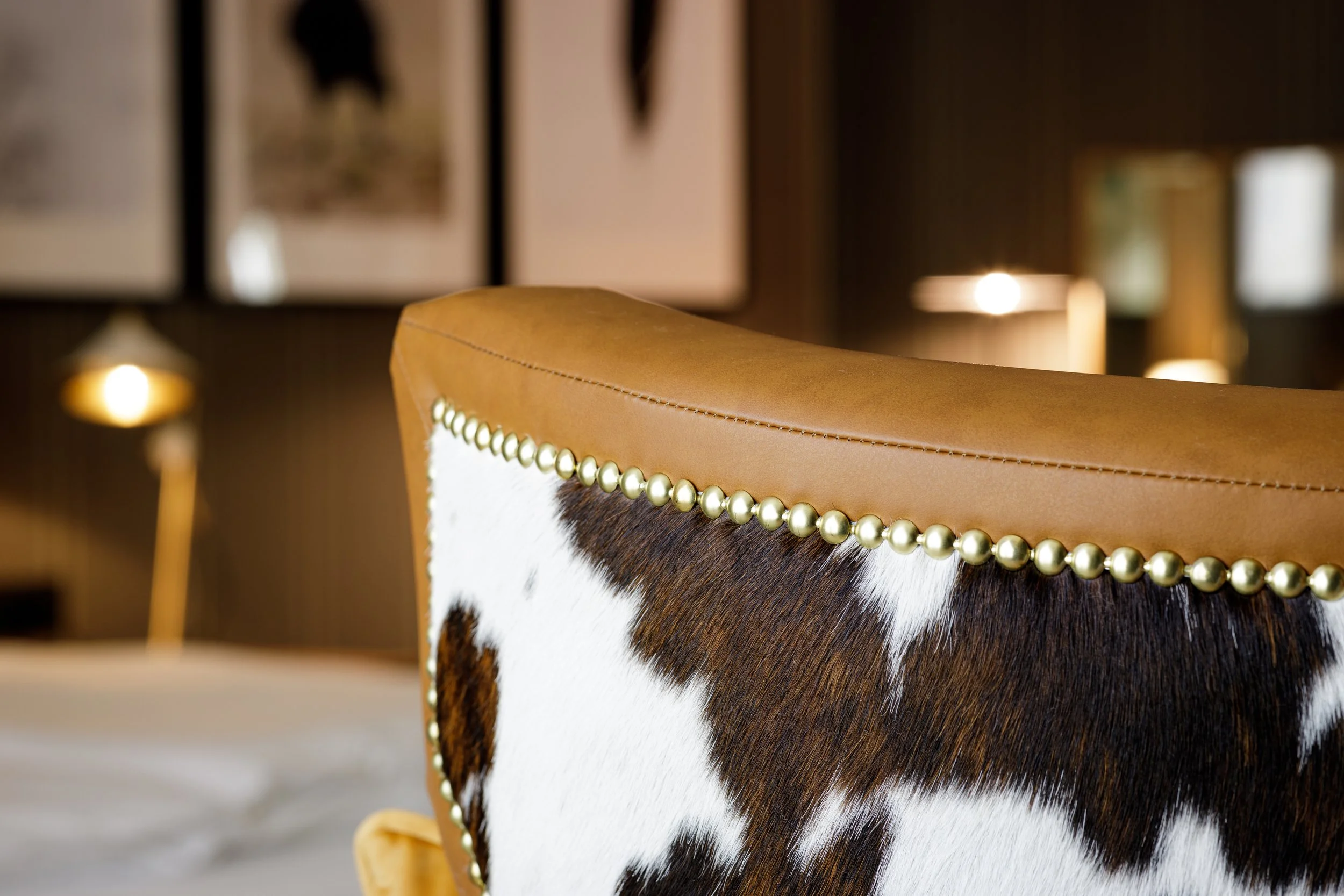 Cowhide and brass stud armchair detail, Royal Hug suite Sunrose 7 boutique hotel Slovenia