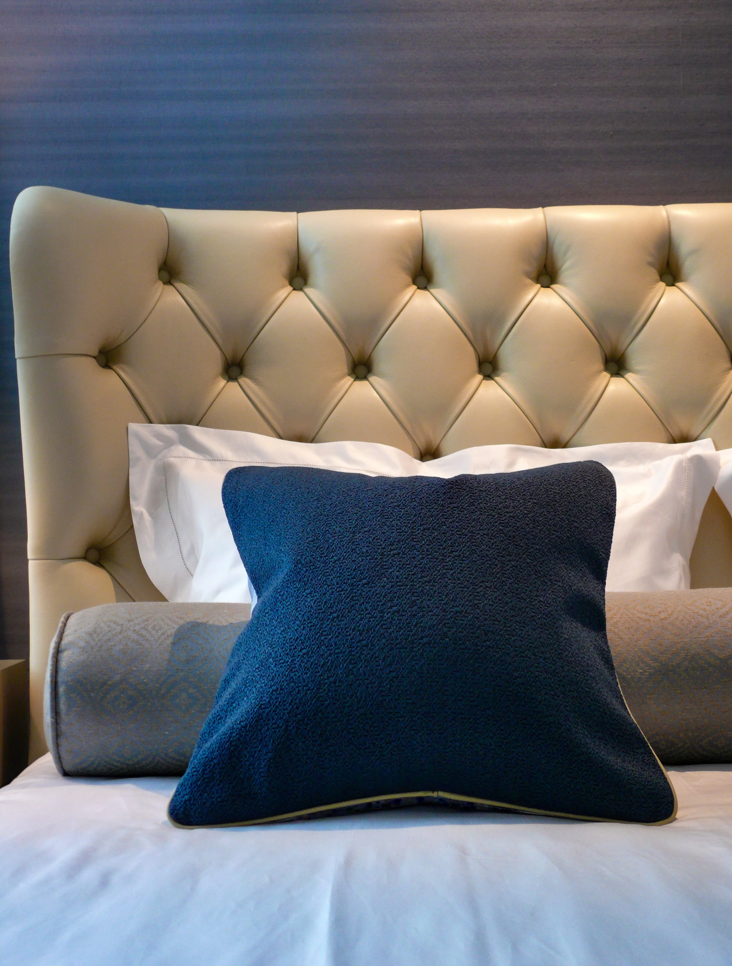 Meridiani tufted leather headboard detail, bedroom Orchard apartment Singapore
