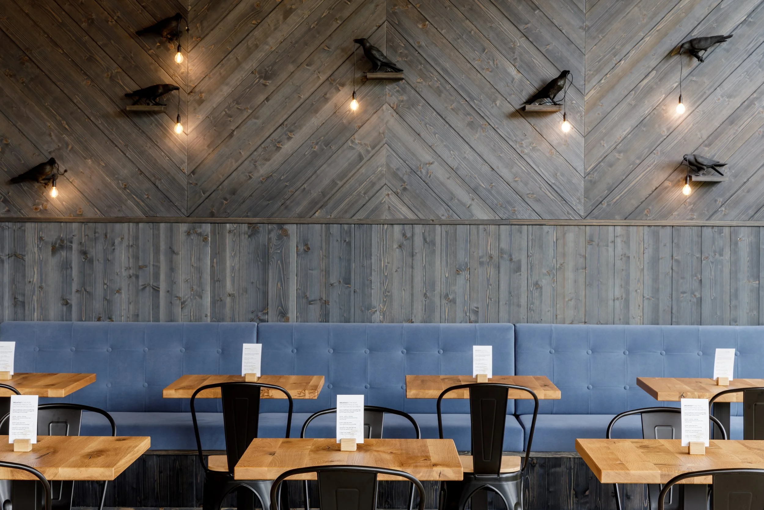 Raven lamps on restaurant dining room wall Sunrose 7 boutique hotel Slovenia