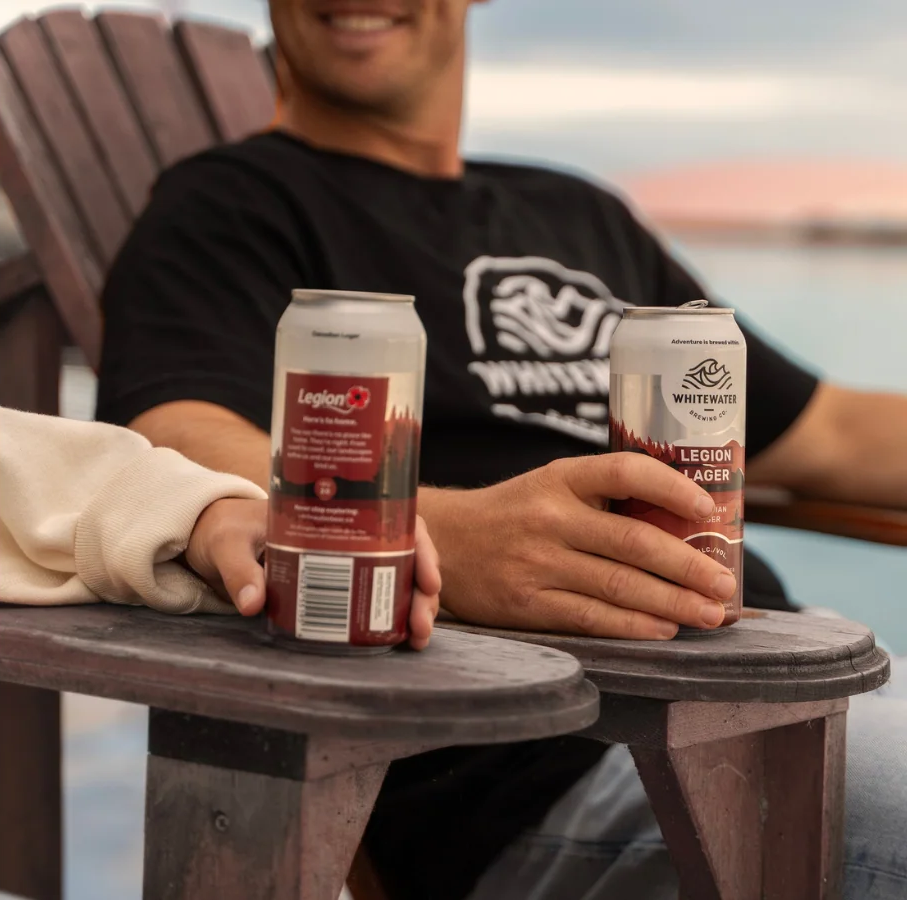 An image of two hands holding drinks from Whitewater Brewing Co