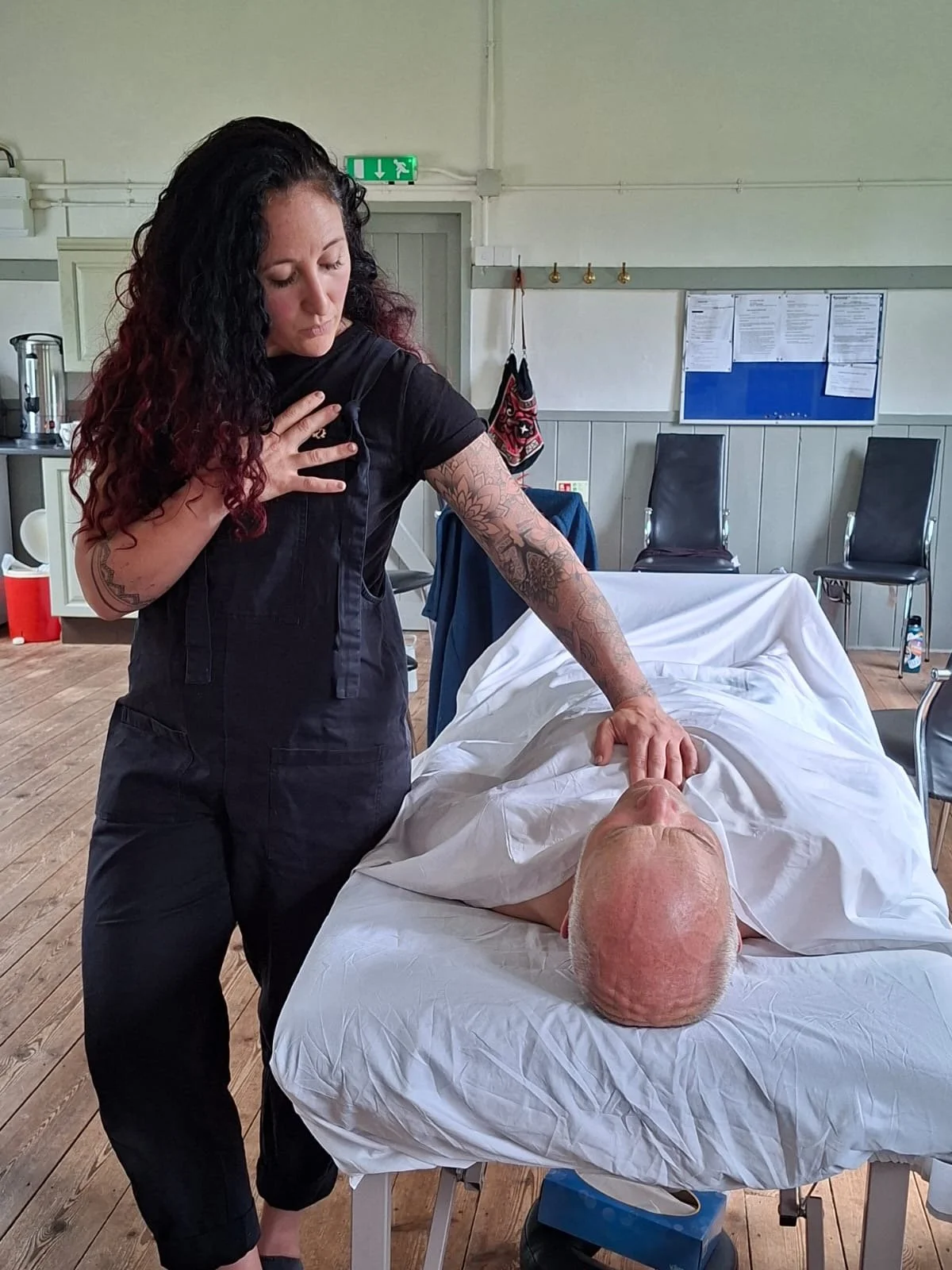 Laura supporting a client during a Sacred Somatic Journey.