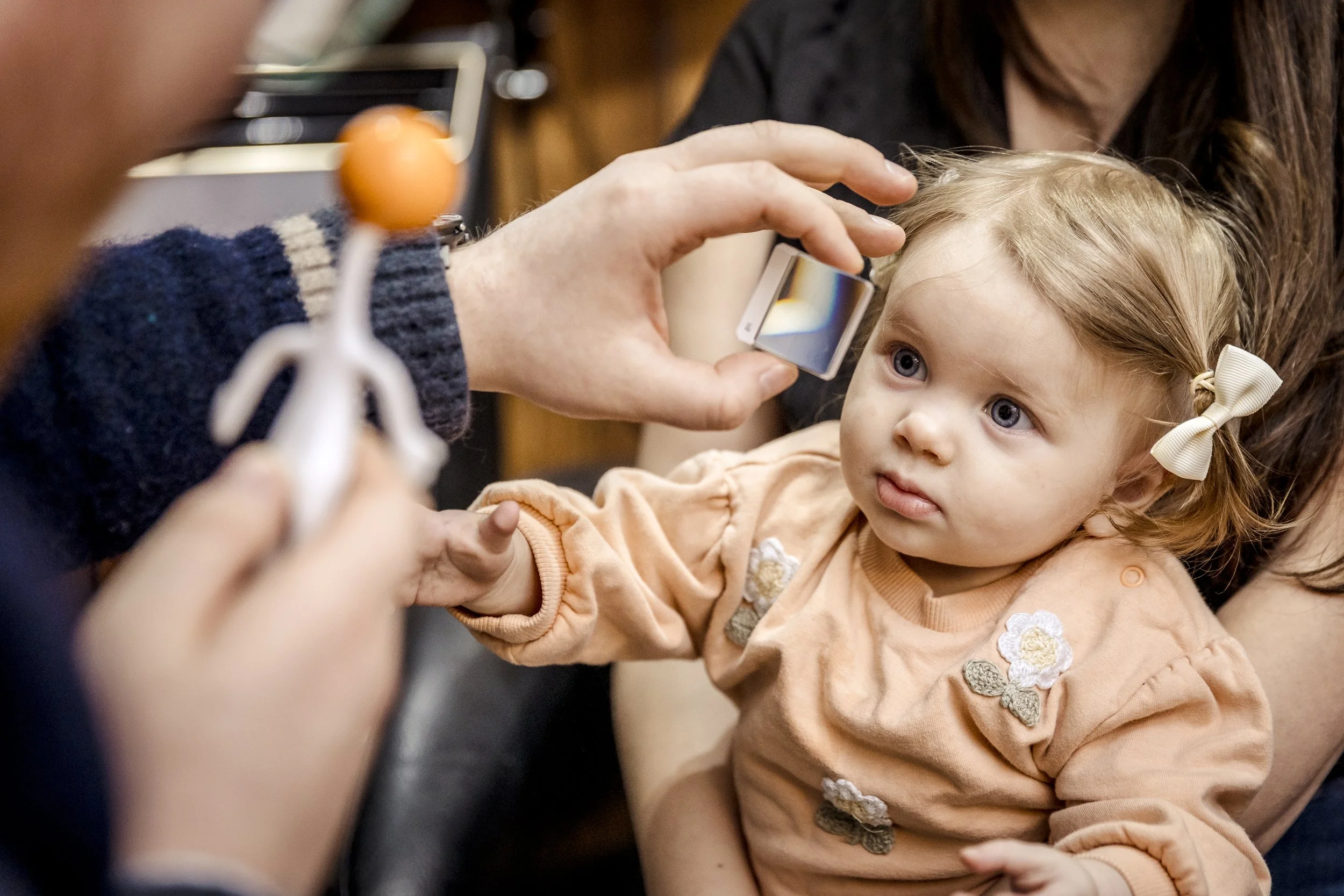 A young child receiving a detailed eye examination and vision therapy appointment at Prof. Christian French - Consulting Neuro-Optometrist.