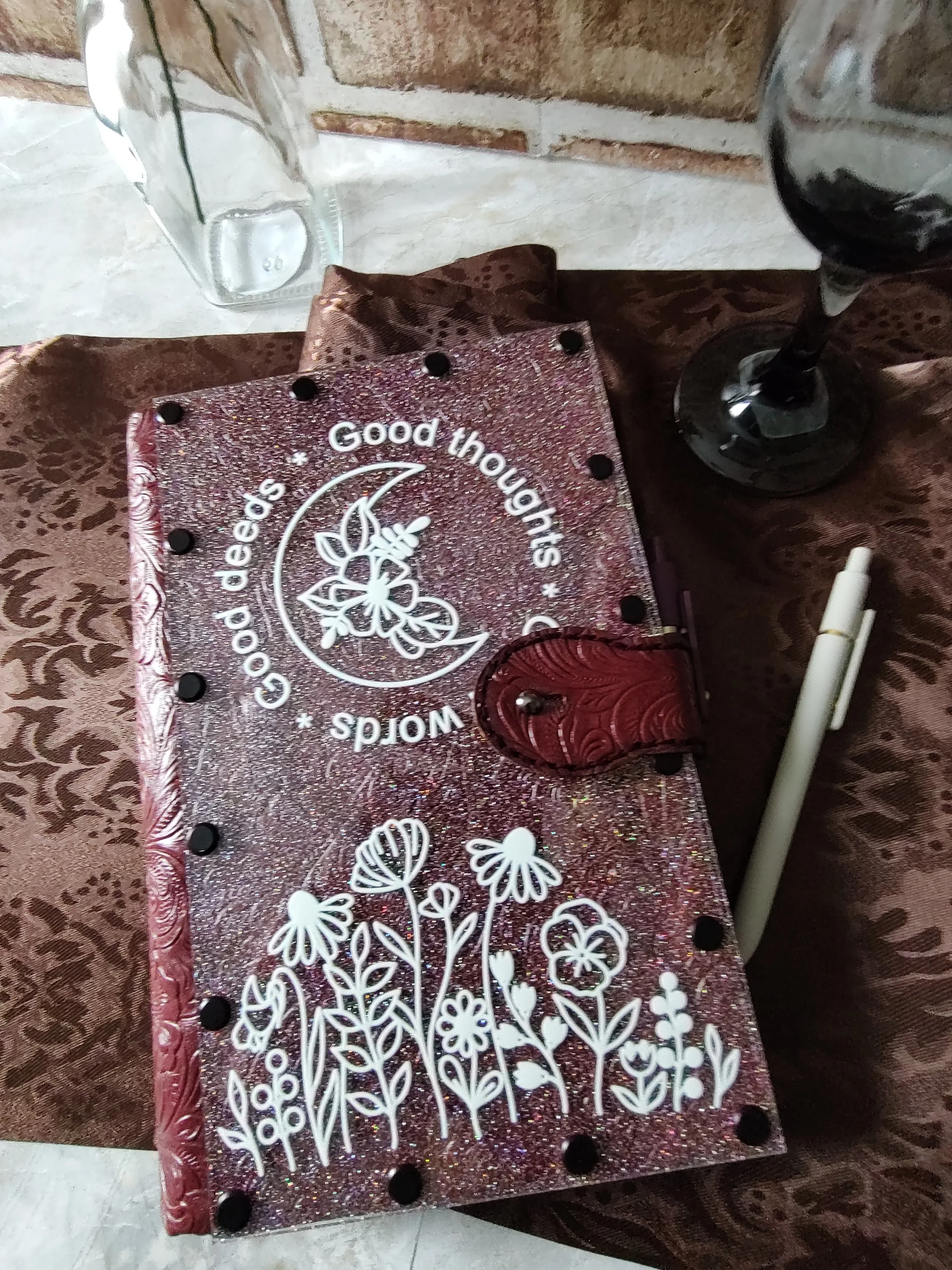 Glitter acrylic with dark red embossed leatherette with tab closure