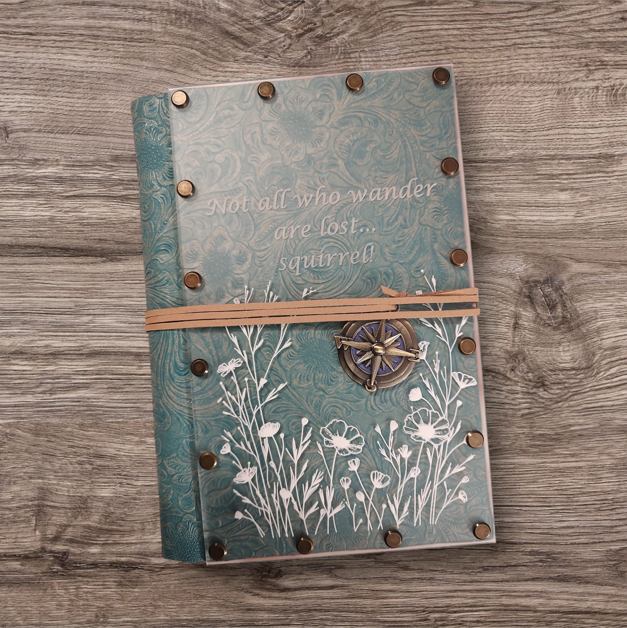 Frosted acrylic with teal embossed leatherette with leather and charm wrap closure