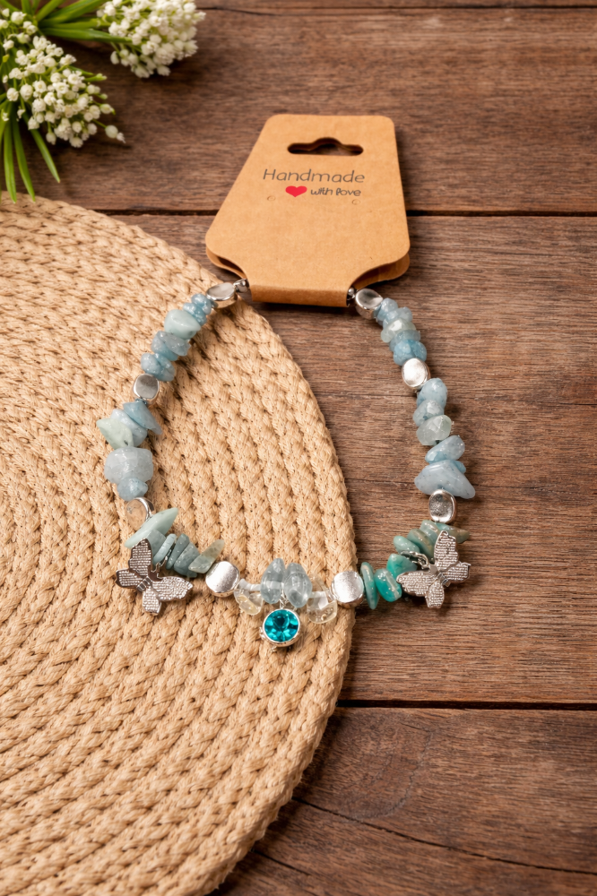 Handmade turquoise beaded bracelet on a wooden table.