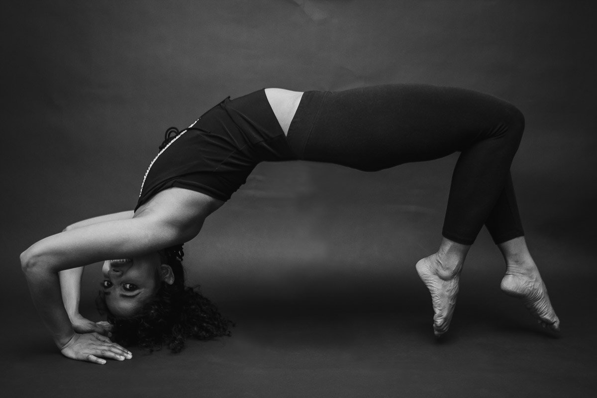 black and white portrait of dancer bending back with her legs levitating of the ground
