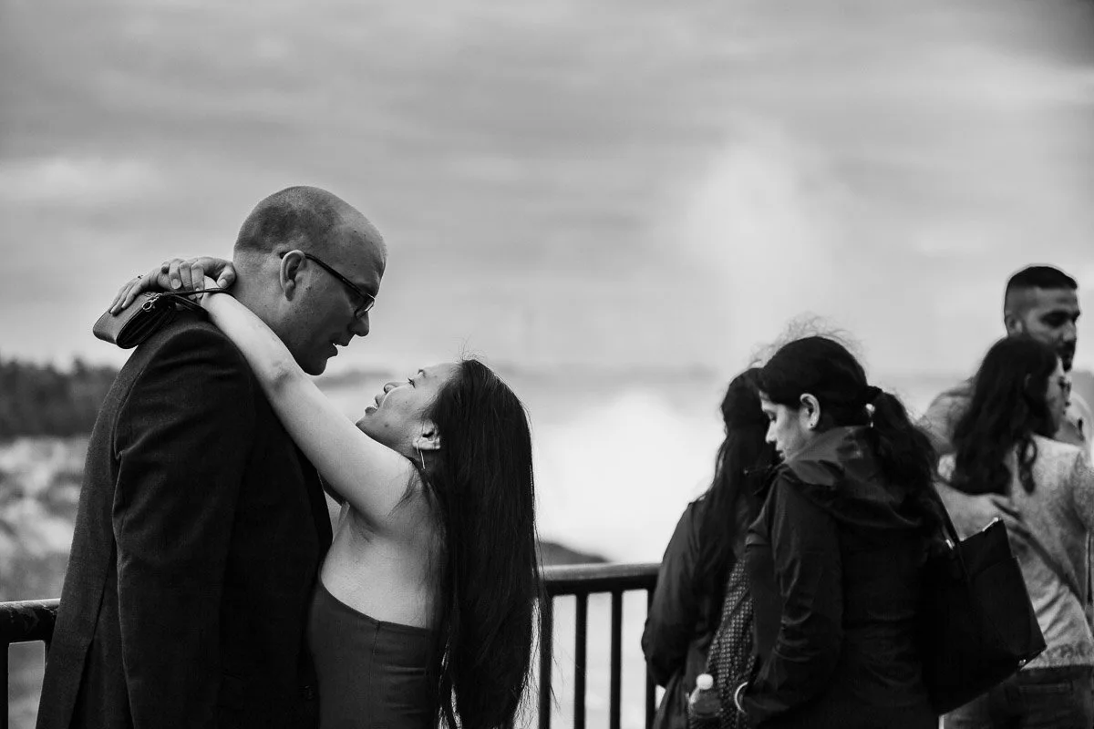 Couple in an embrace enjoying Niagara Falls