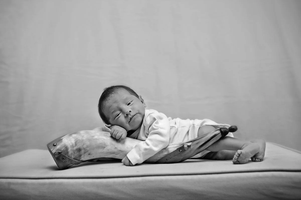 baby on a heirloom horn that belong to grandfather