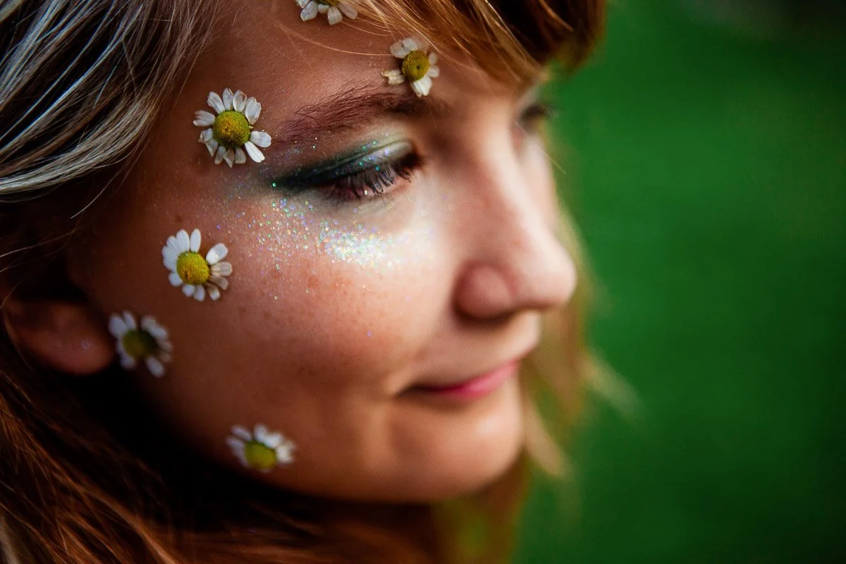 Dreamy childhood portrait with little flowers and sparkle