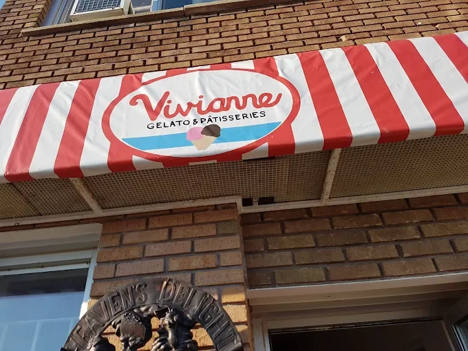 Red and white striped awning with a sign that reads "Viviane Gelato & Pâtisseries" and images of ice cream cones.