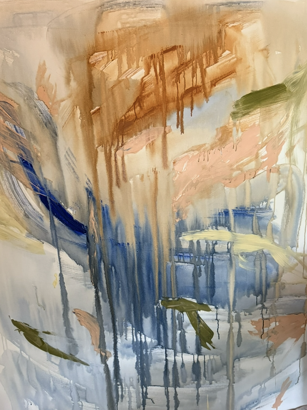 An abstract painting with sweeping brushstrokes in tan, blue, peach, green, and cream tones, with drips and layered textures.