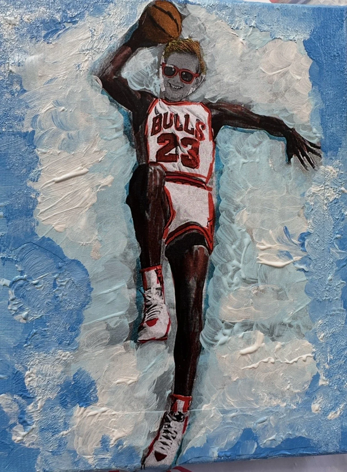 A painting of a basketball player in a Chicago Bulls uniform with the number 23, holding a basketball, wearing sunglasses, and smiling. The background consists of blue and white textured brushstrokes.
