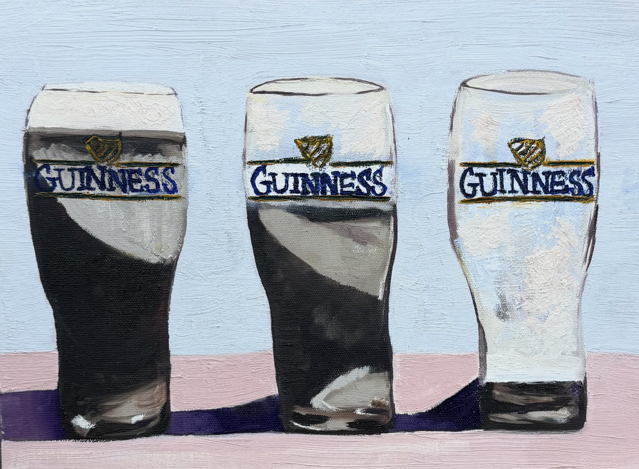Three Guinness beer glasses with ice and logo, against a light background.