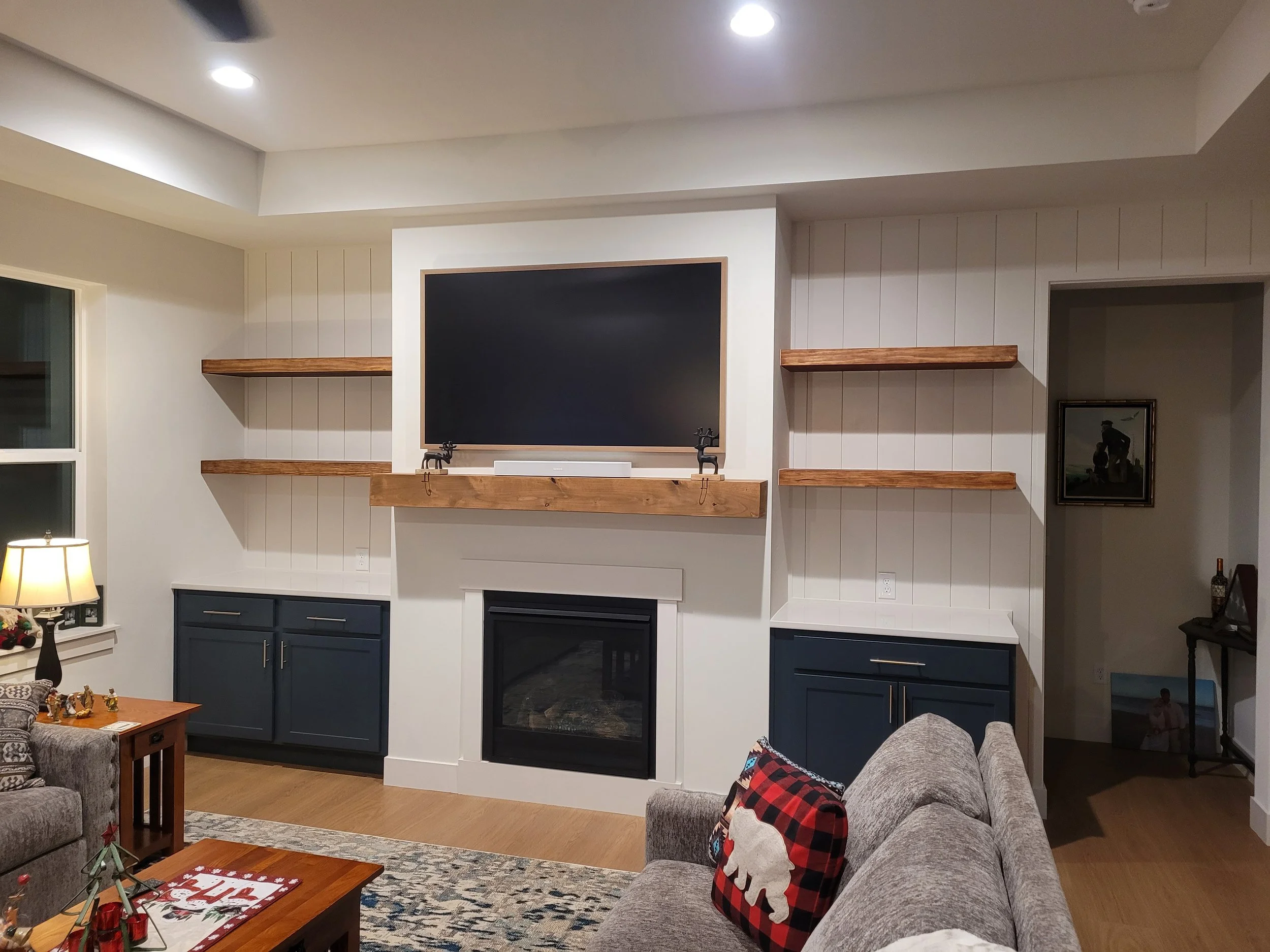 Mantle with floating shelves, shiplap, and cabinets