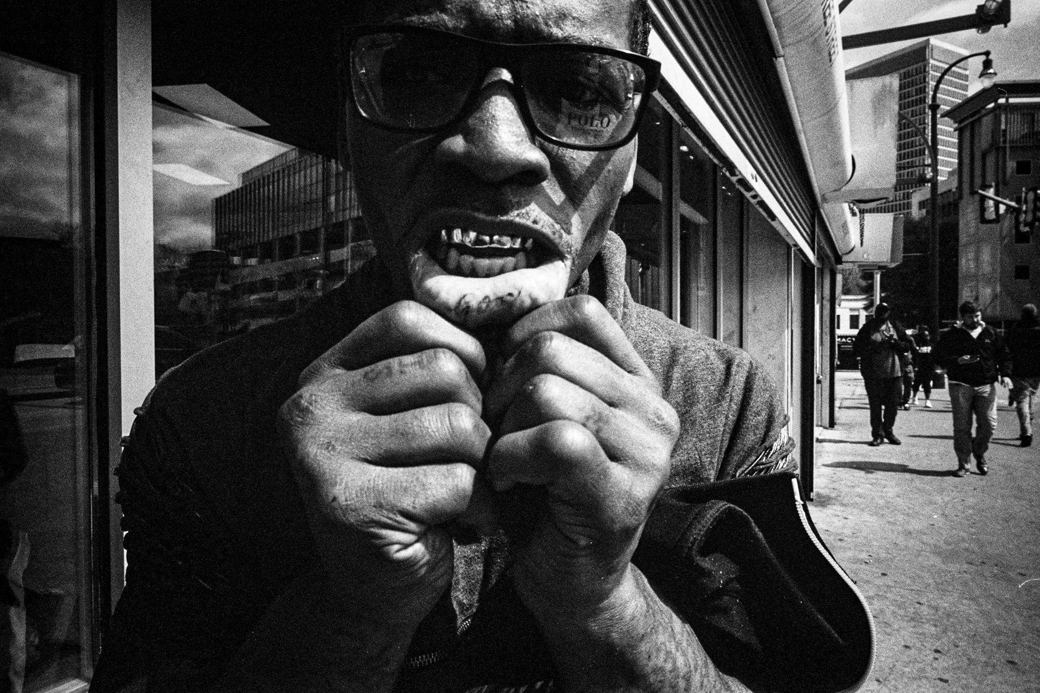 A Man shows his tattoo in Atlanta - Photographed by Quintavius Oliver with a Leica M7 + 21mm Super Angulon F/3.4 + Ilford HP%+