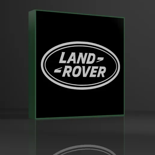 A lit display with the Land Rover logo on a black background, with a green-glowing edge.