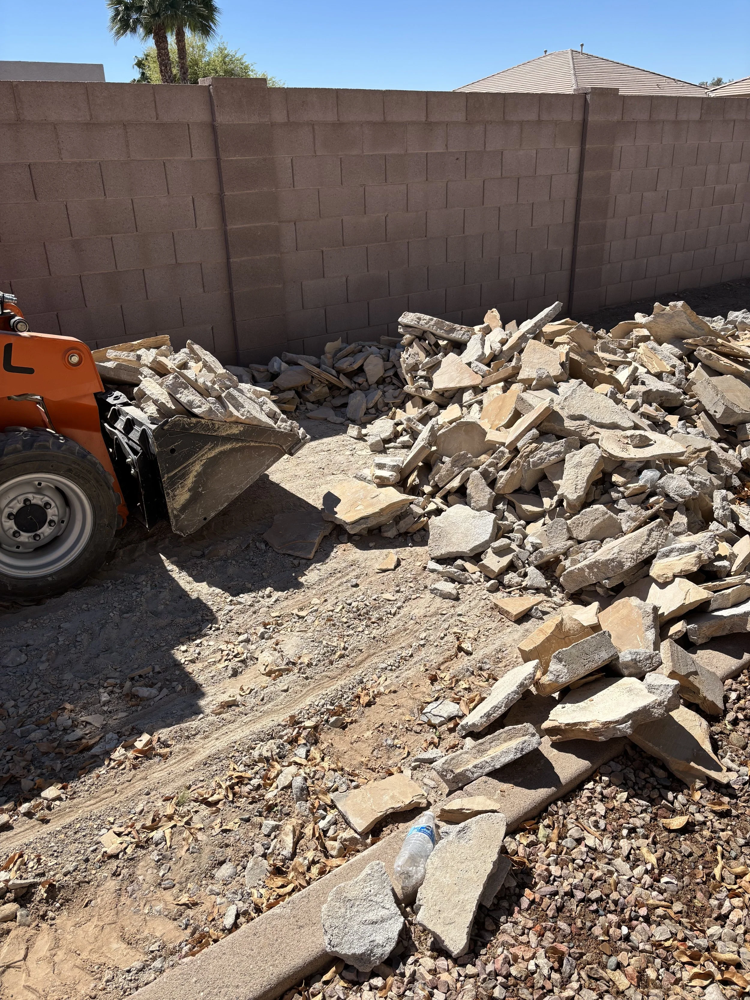 Construction site with a pile of broken concrete and rocks ready for debris removal in Phoenix